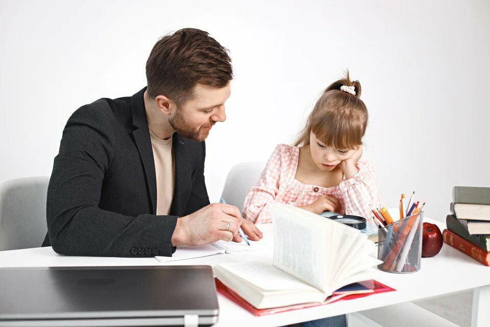 A special needs child studying with a man