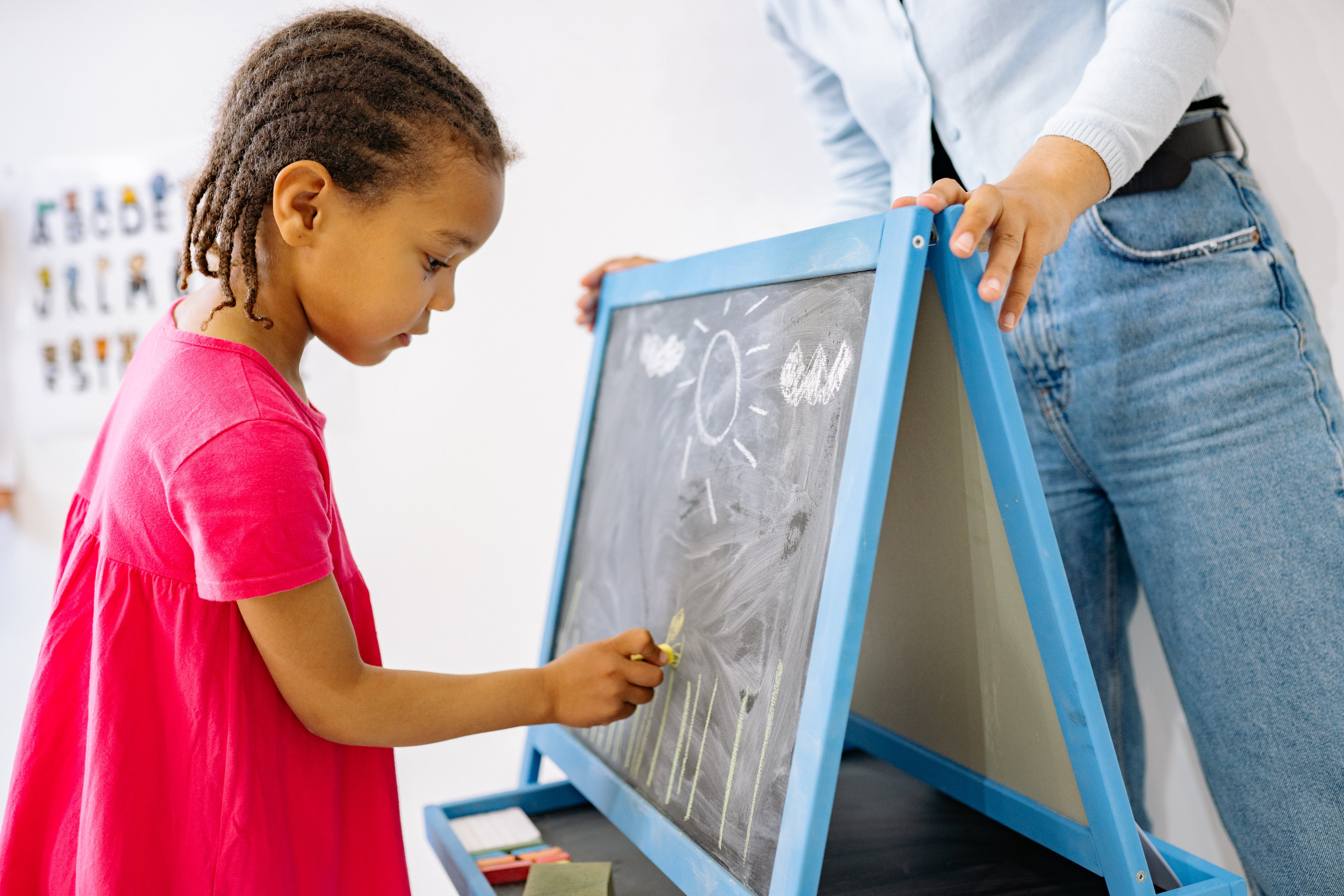 A child writing on a board