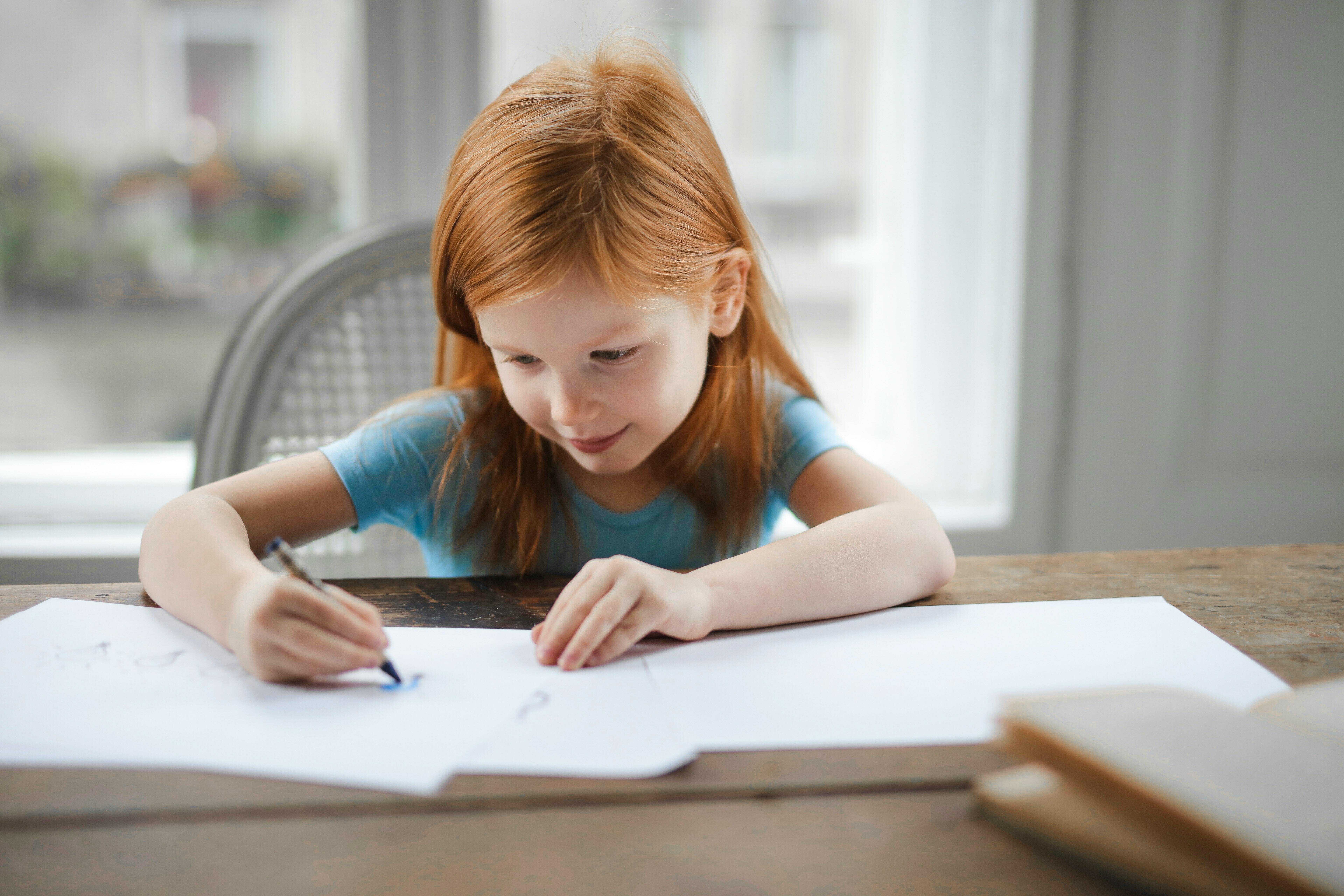 Little child writing on a paper