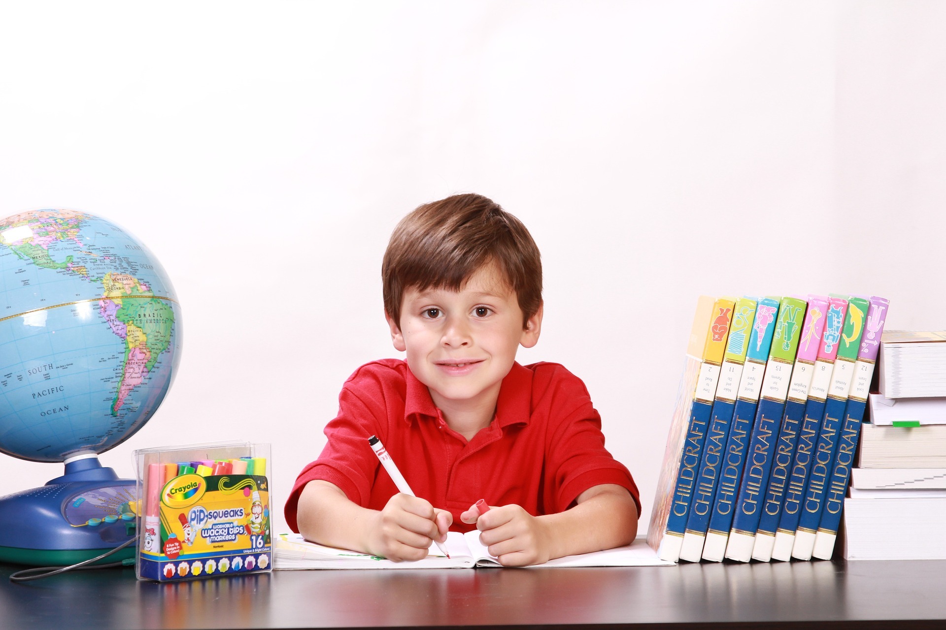 A boy holding a pen