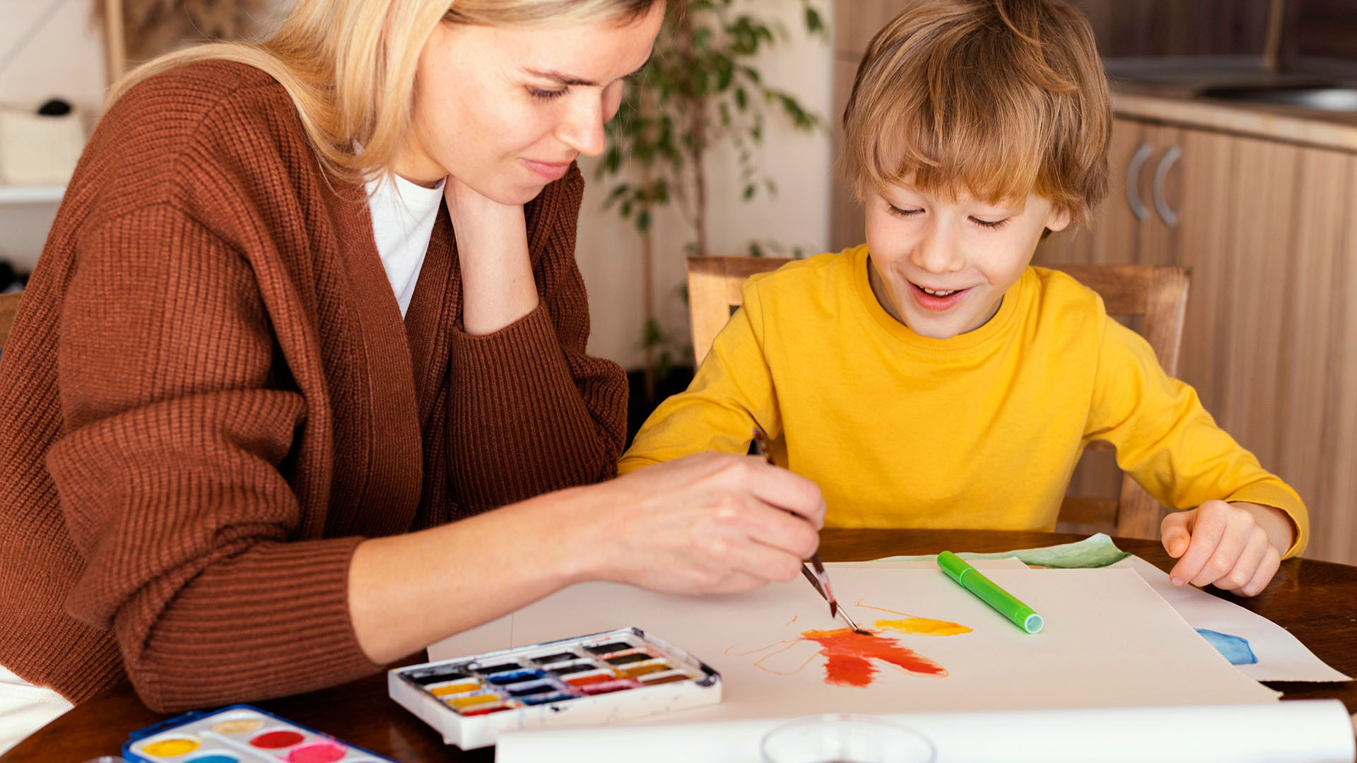 Teacher Showing Drawing to a Child Great Home School Convensions