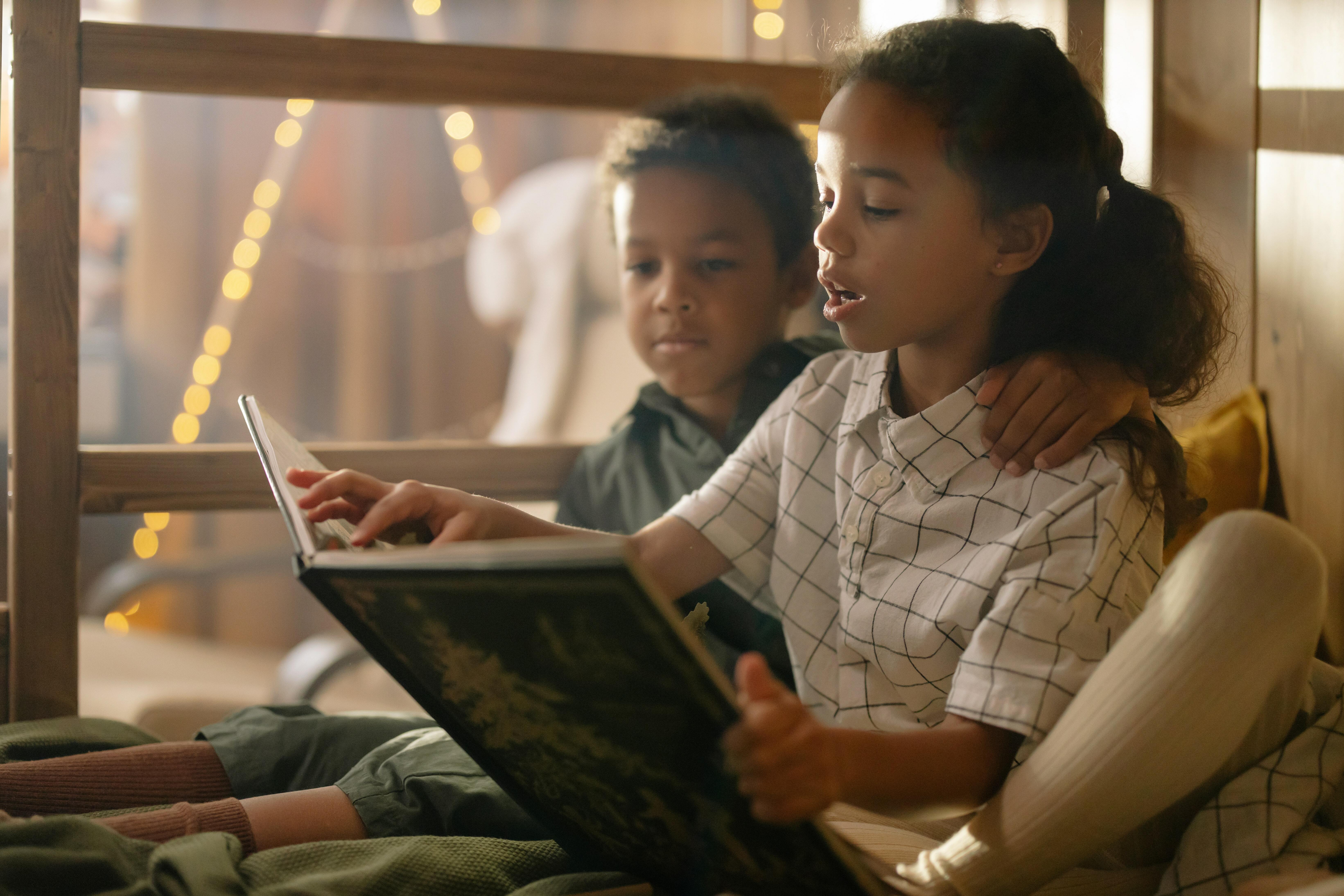 Two kids reading a book