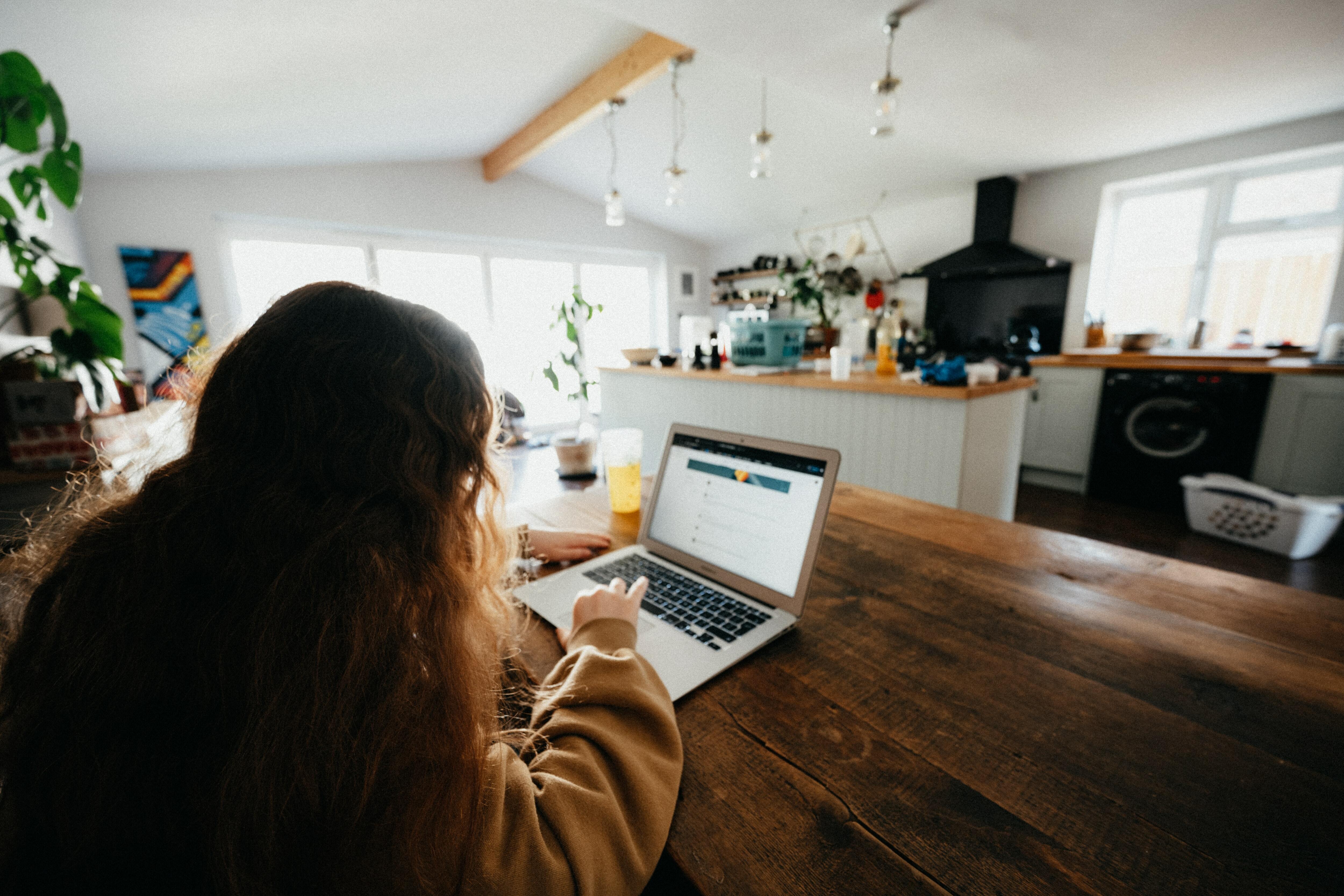 A female pressing laptop at home