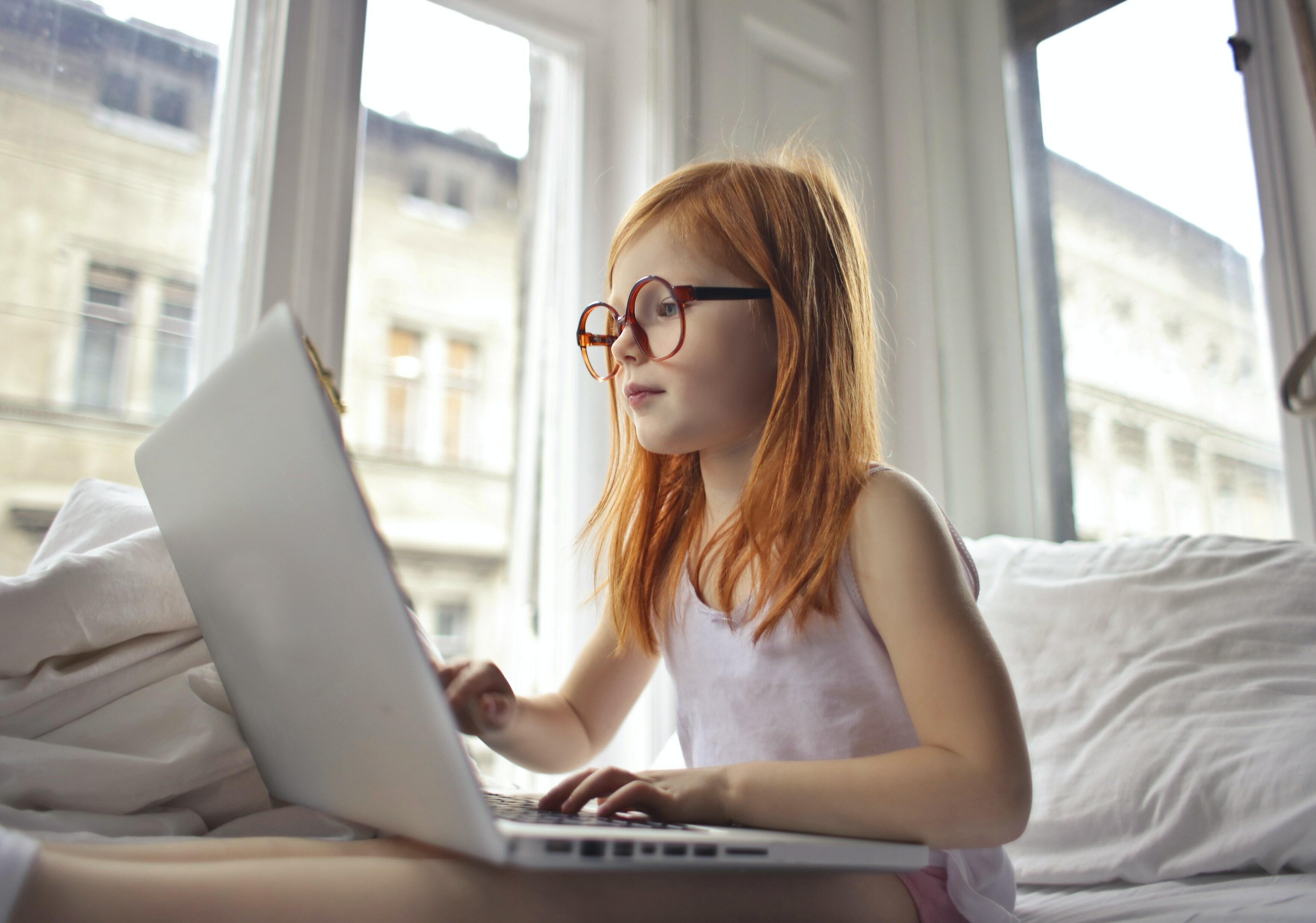 Child pressing laptop