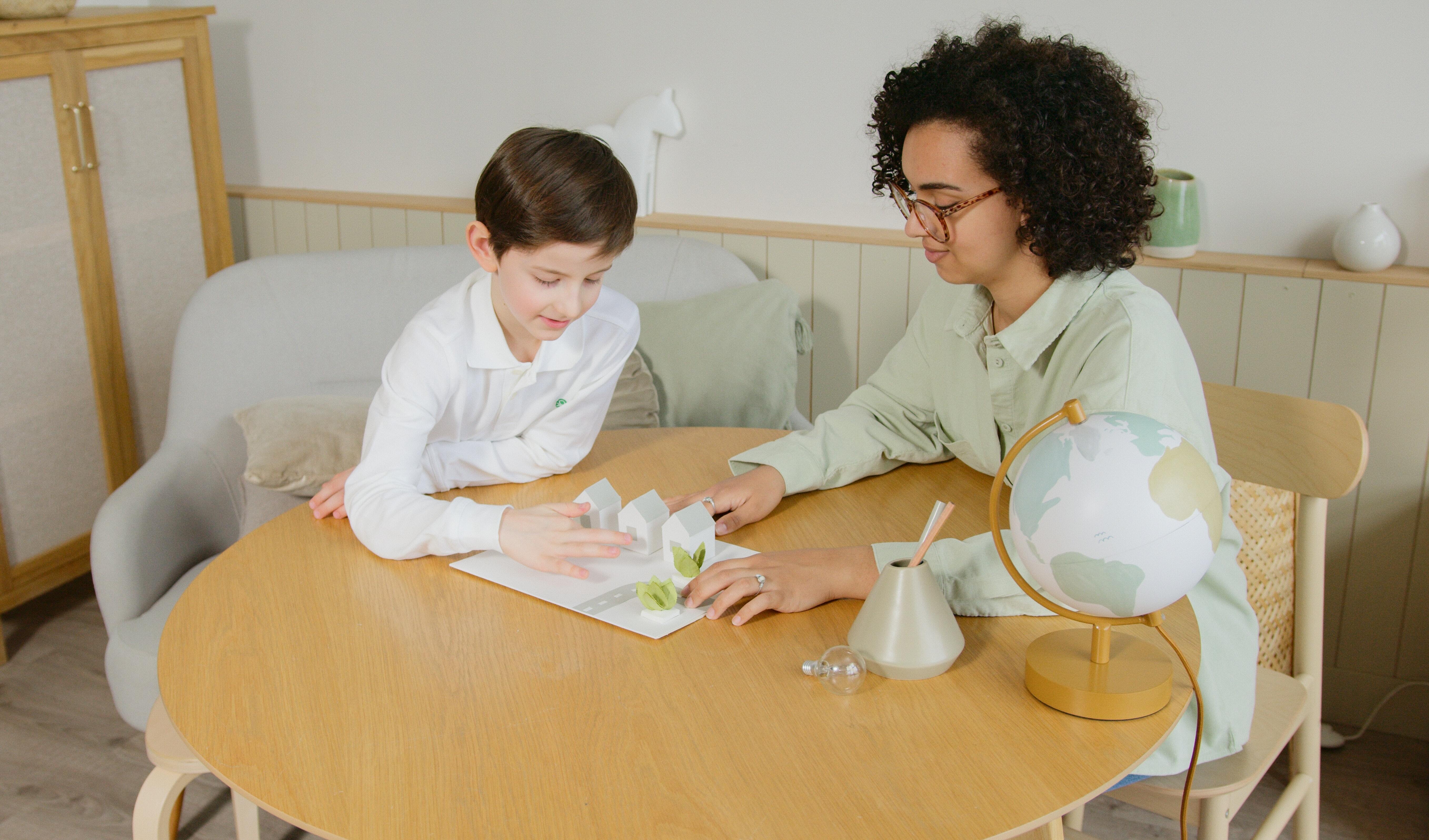 A woman homeschooling a boy