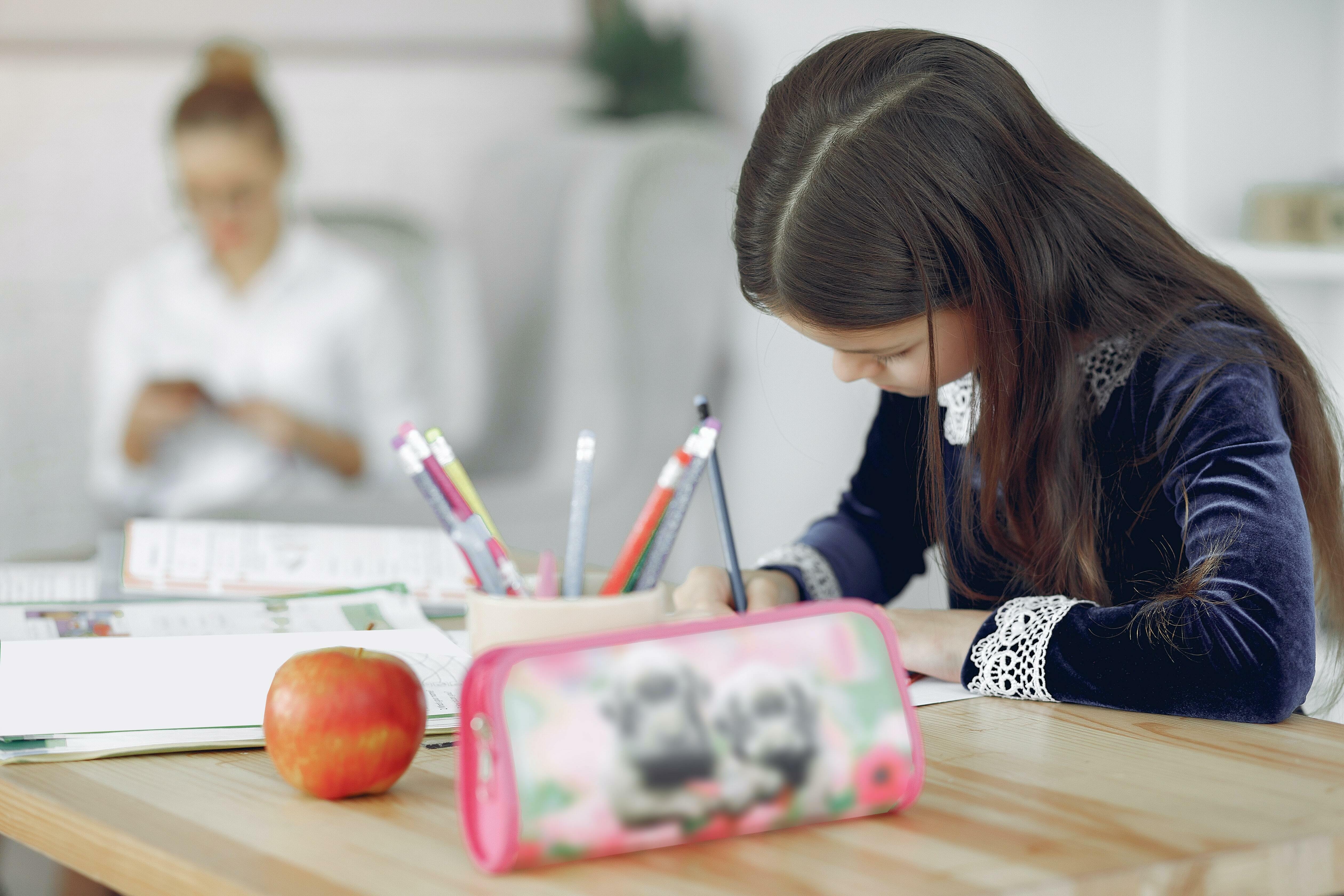 A girl child doing her work at home