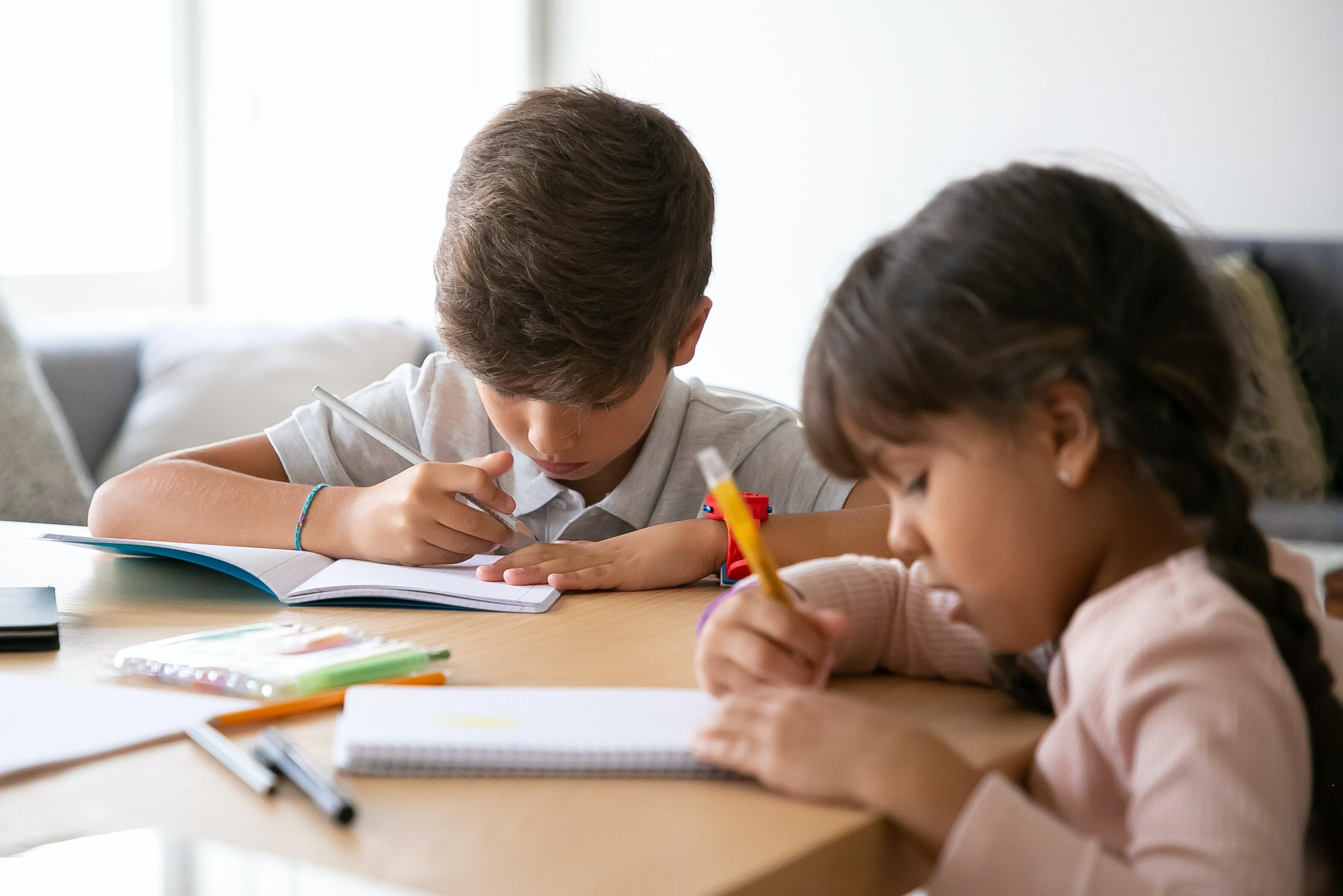 Children writing on their book