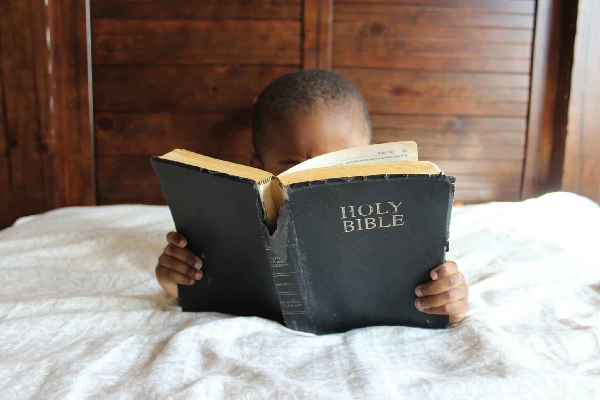 A child reading a bible