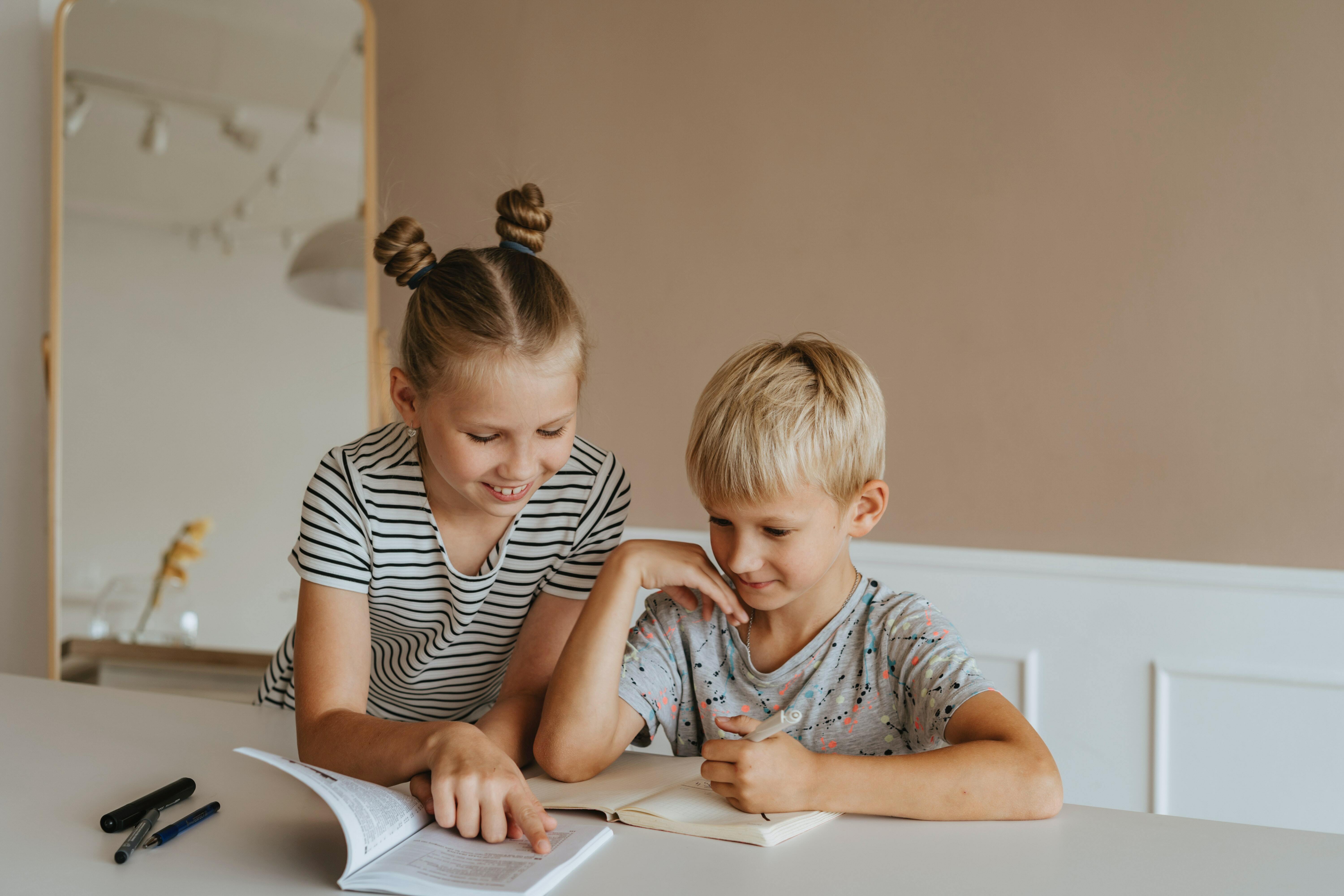 Two children reading a book