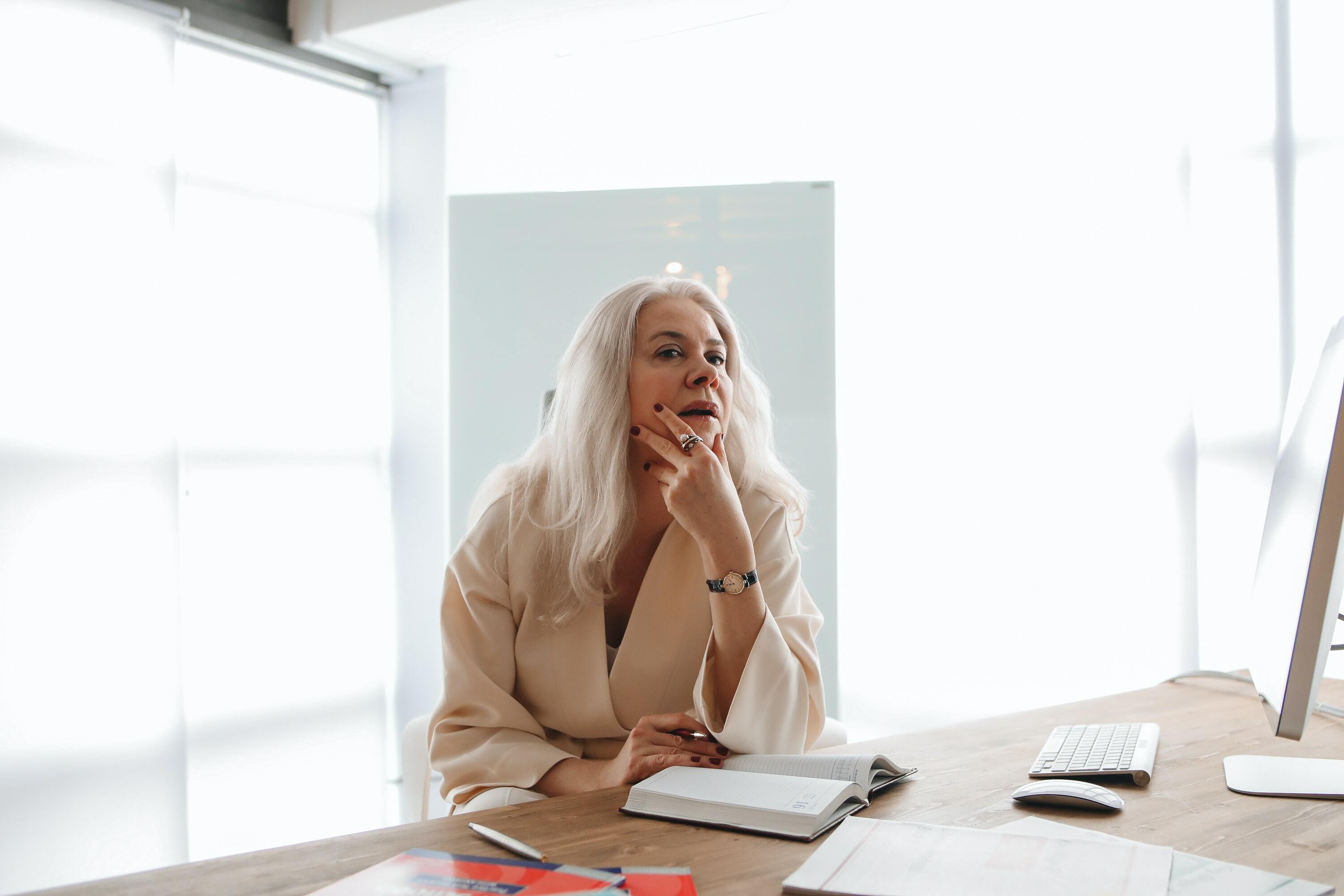 Woman Sitting by the Wooden Table While Thinking