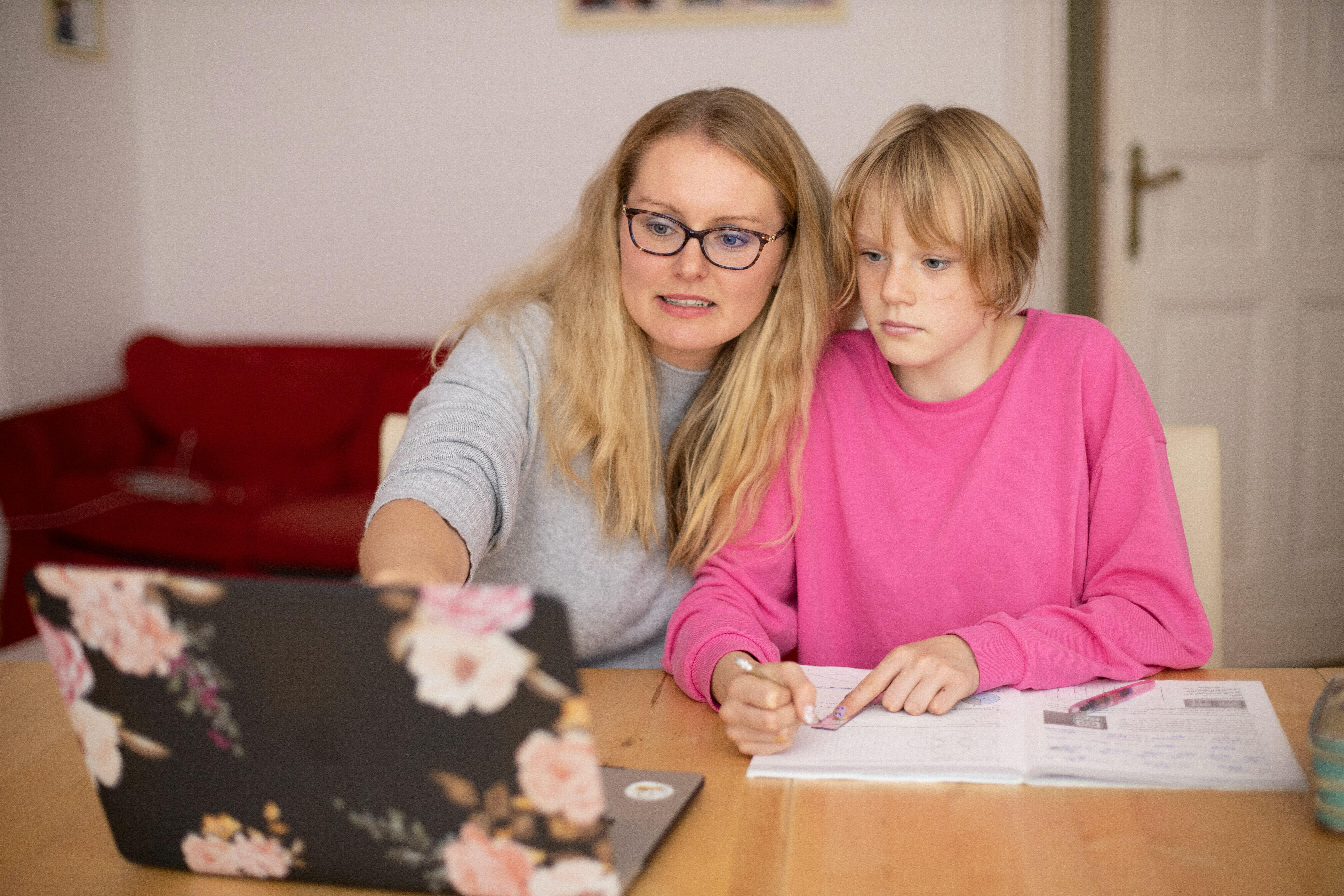 A mother homeschooling a child