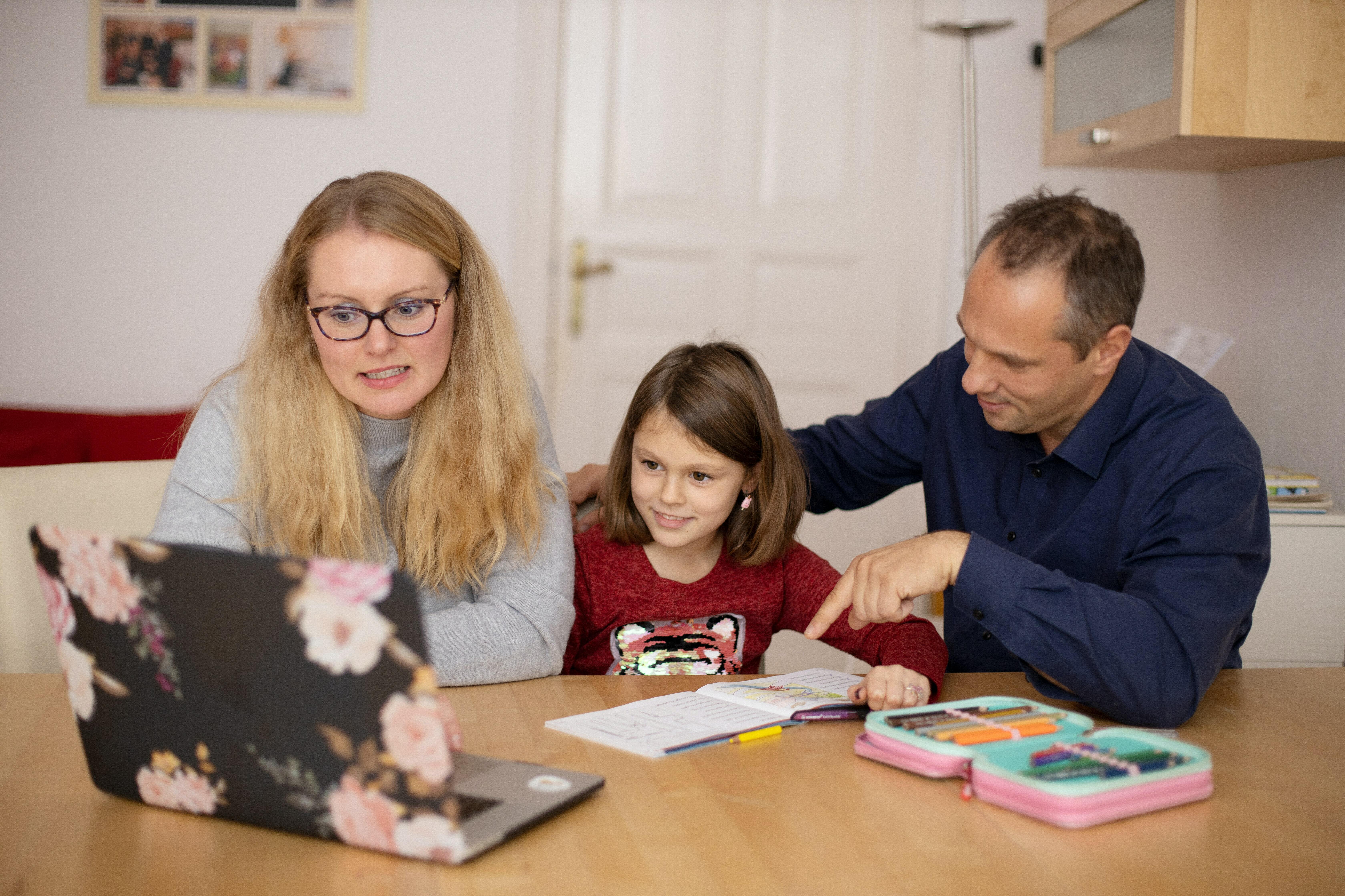 A mother and father homeschooling their child