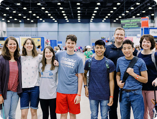 several children and adults smiling at convention