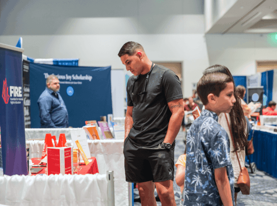 man and children at convention booths