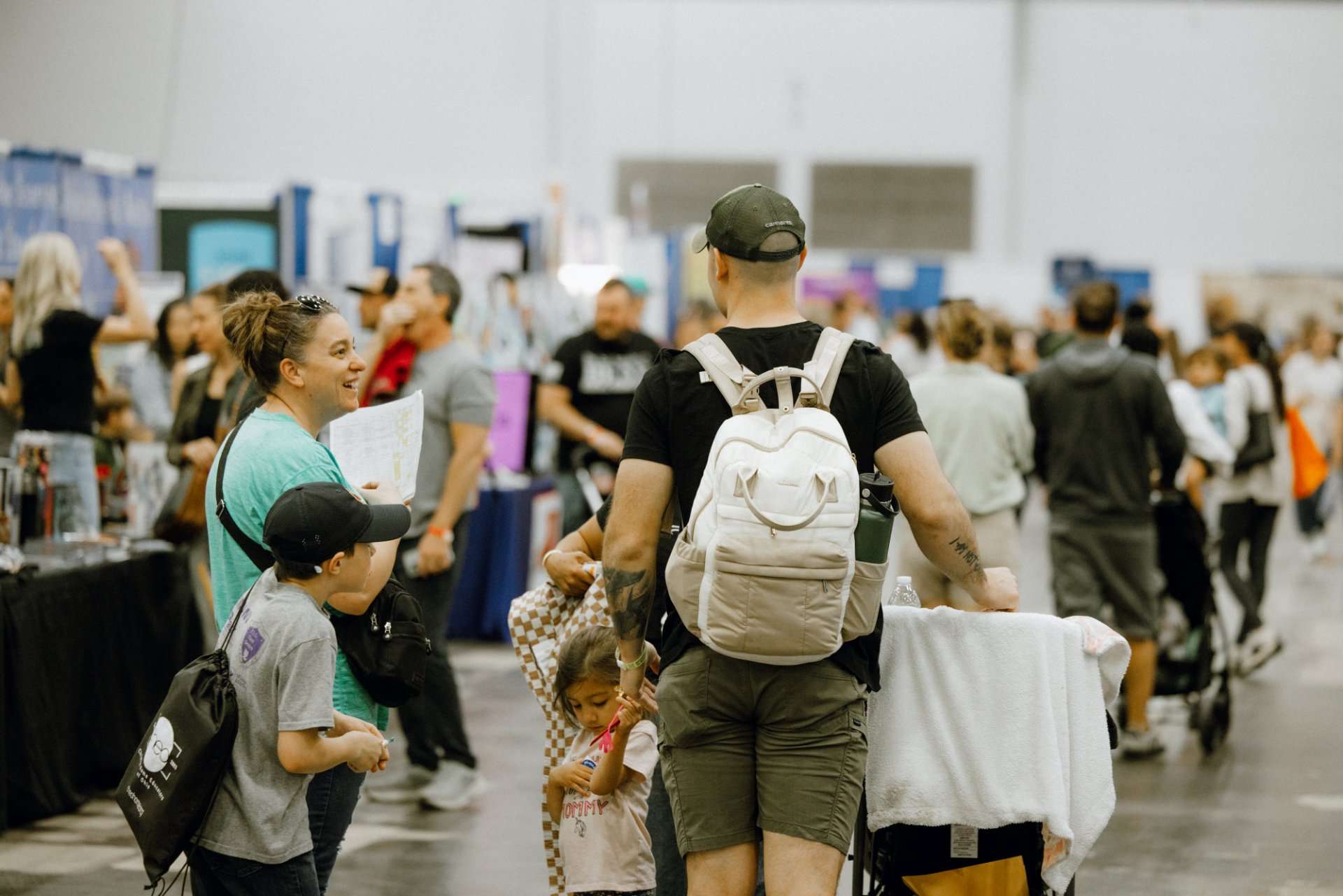 man with stroller and family at convention