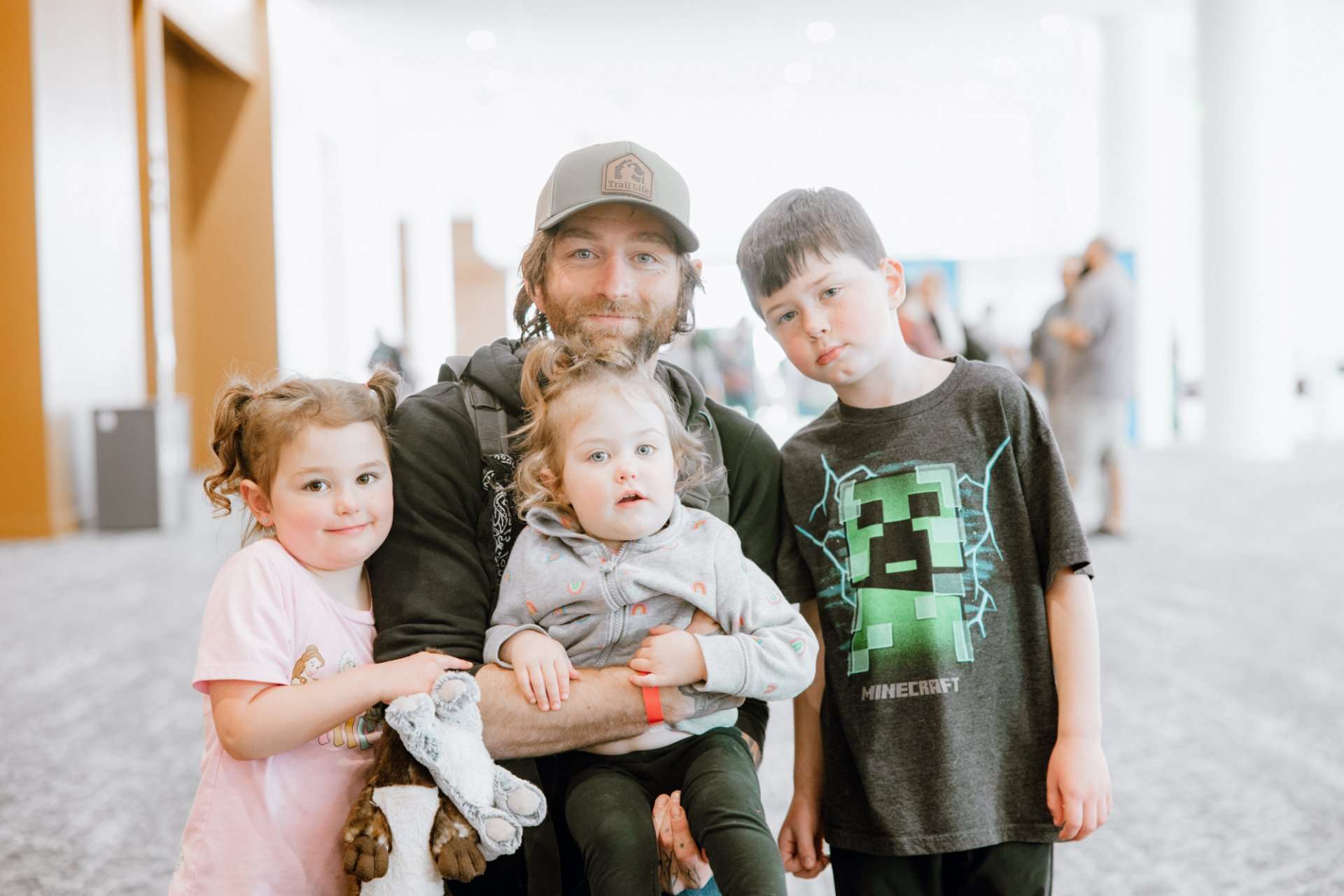man with three children at convention