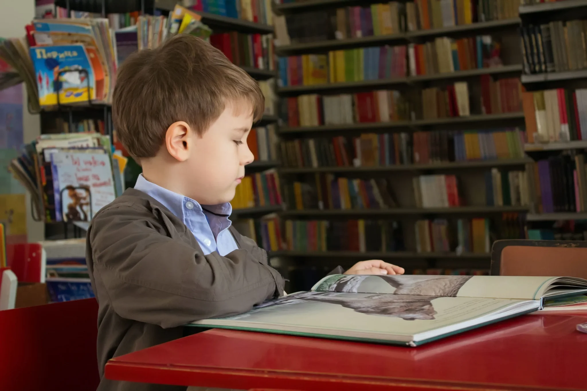 A boy turning pages of a book