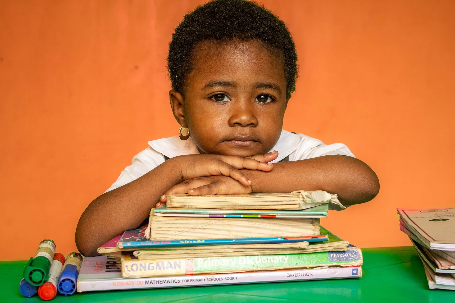 Child leaning on a book