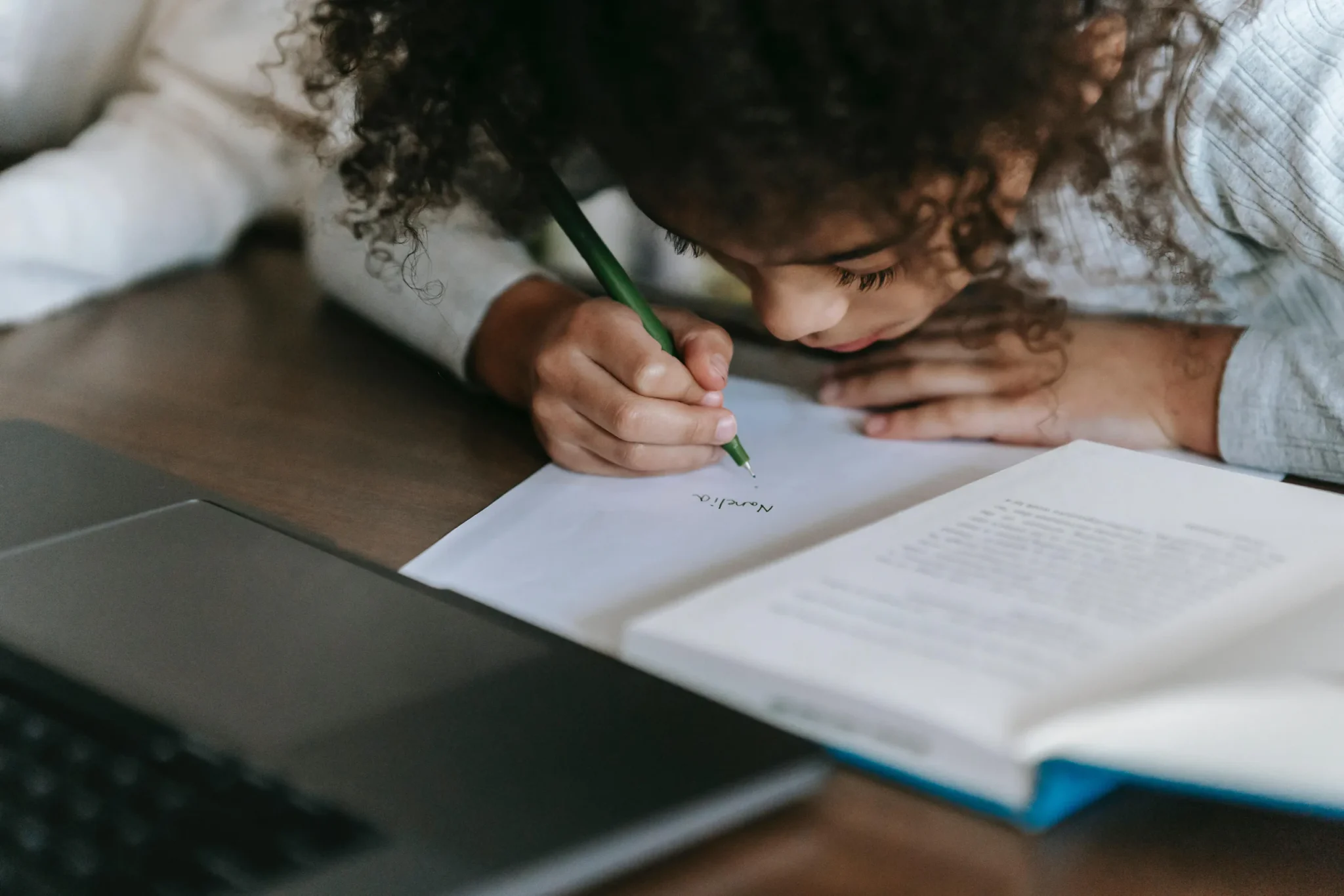 A child writing on a book