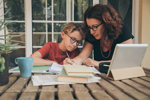 A child studying with a woman
