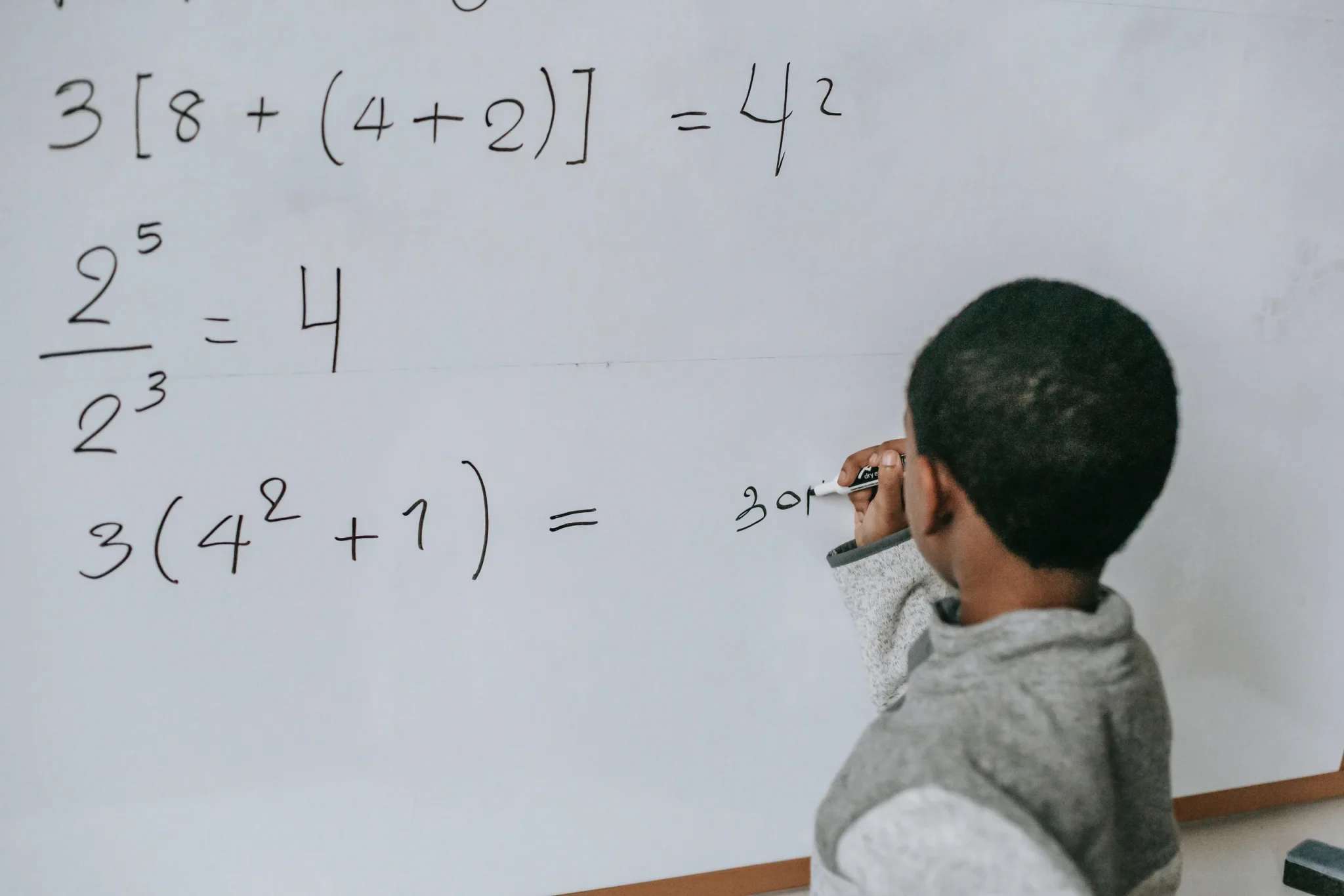 A child writing on the board