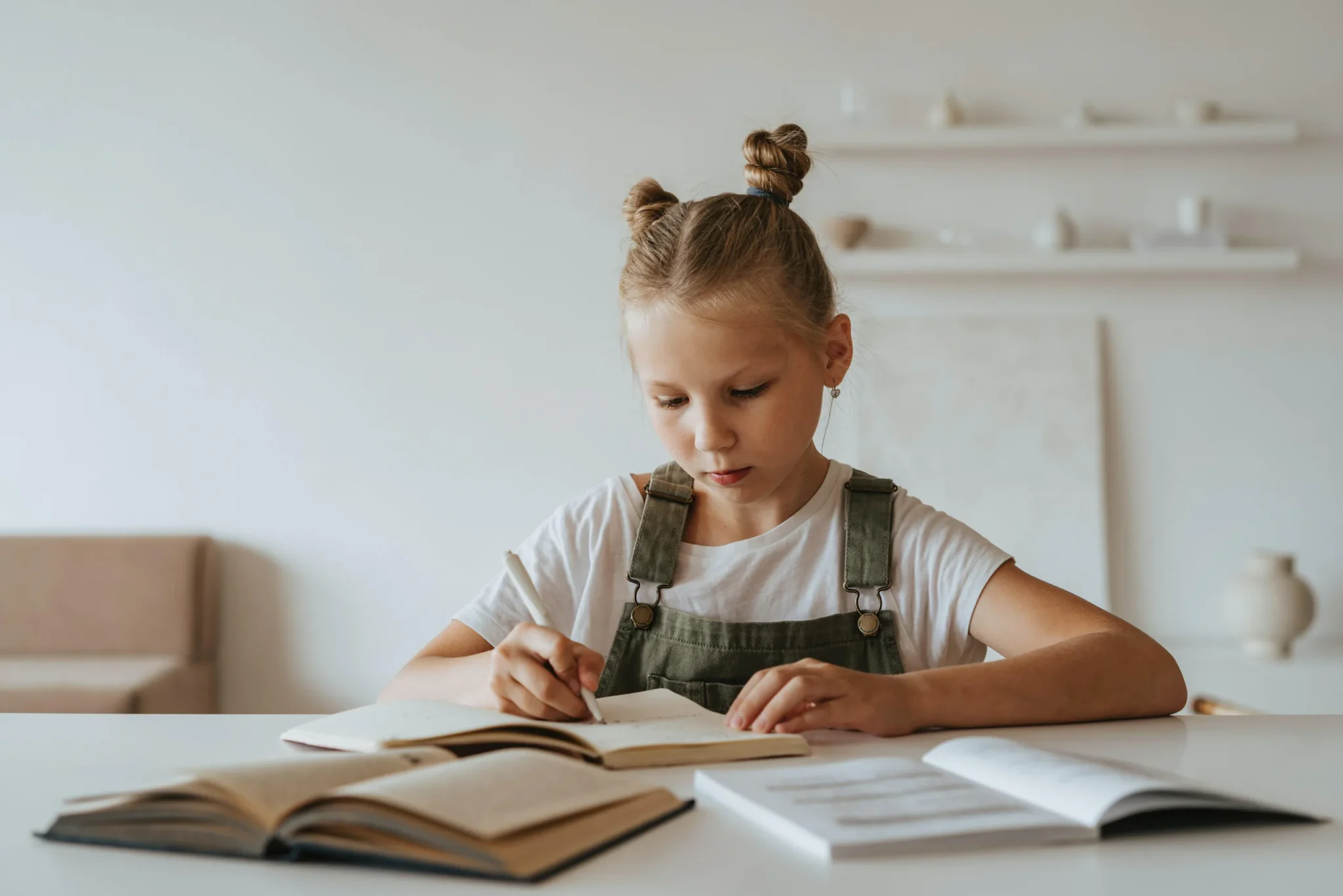 A female child writing on a book