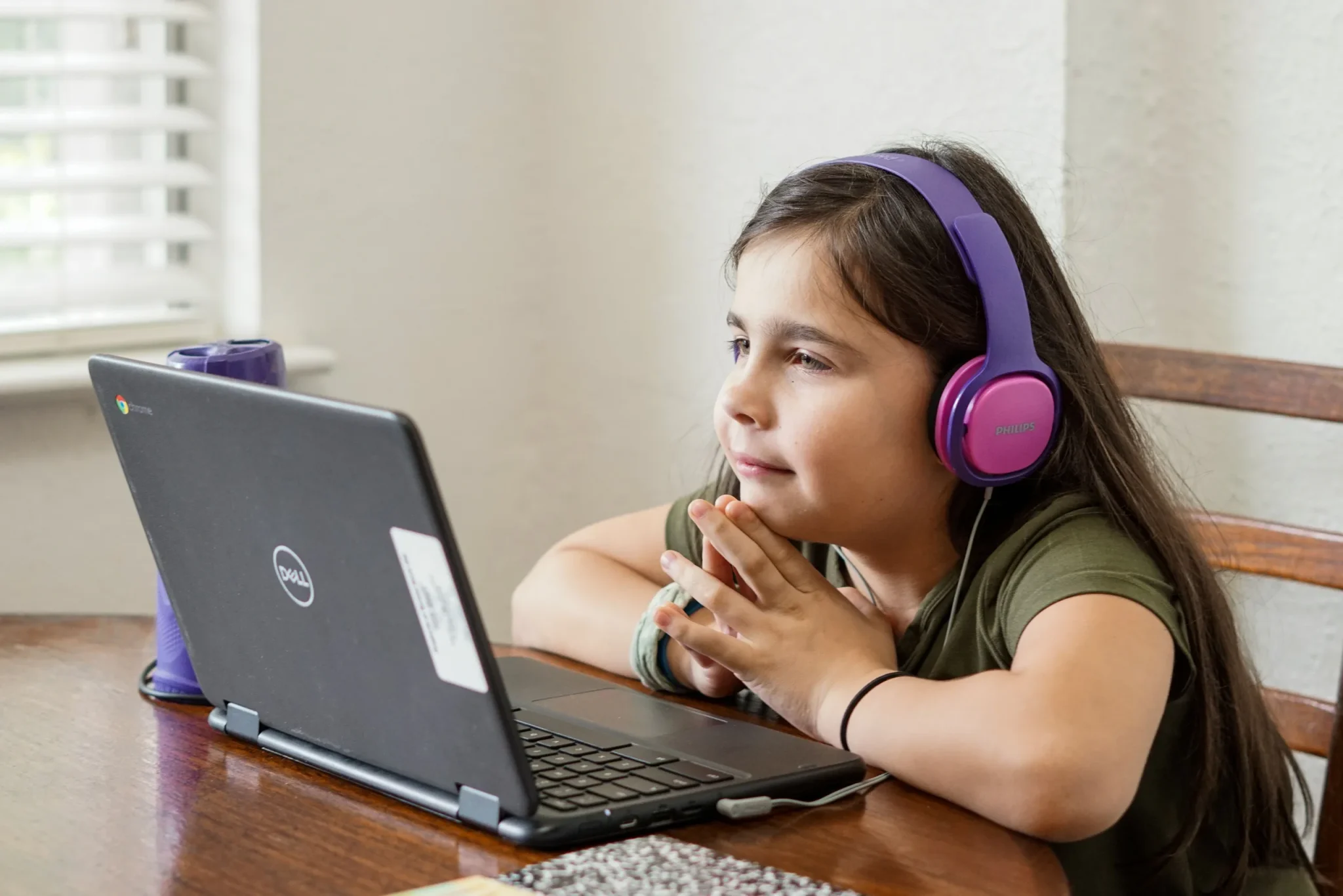 A girl staring at a laptop screen