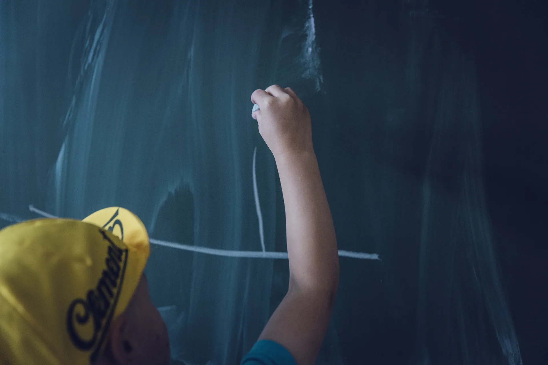 A child writing on a board