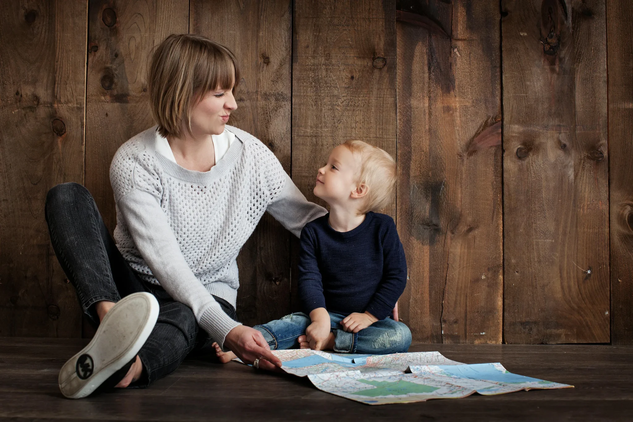 A woman and a child sitting on the floor
