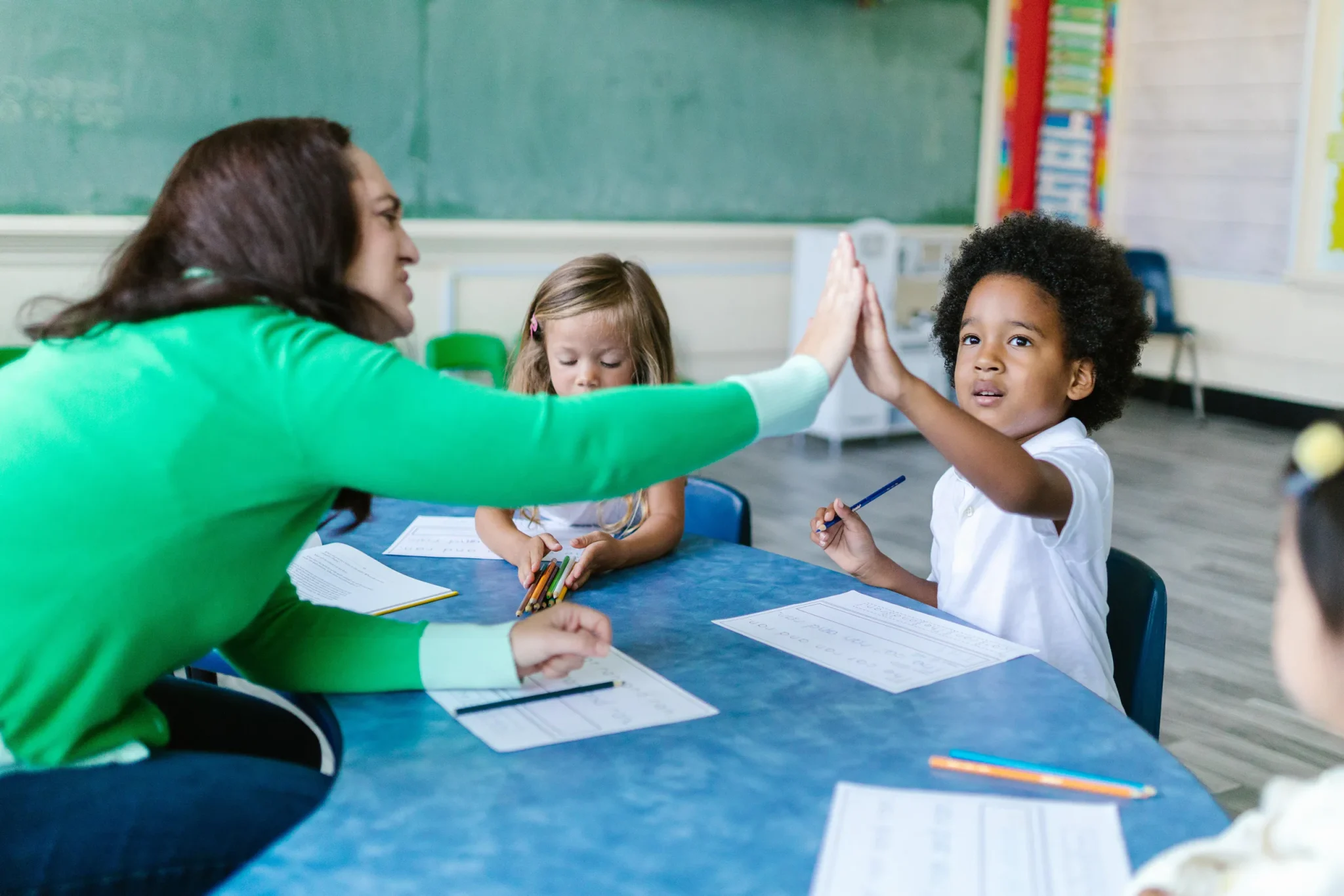 A woman high-fiving a child