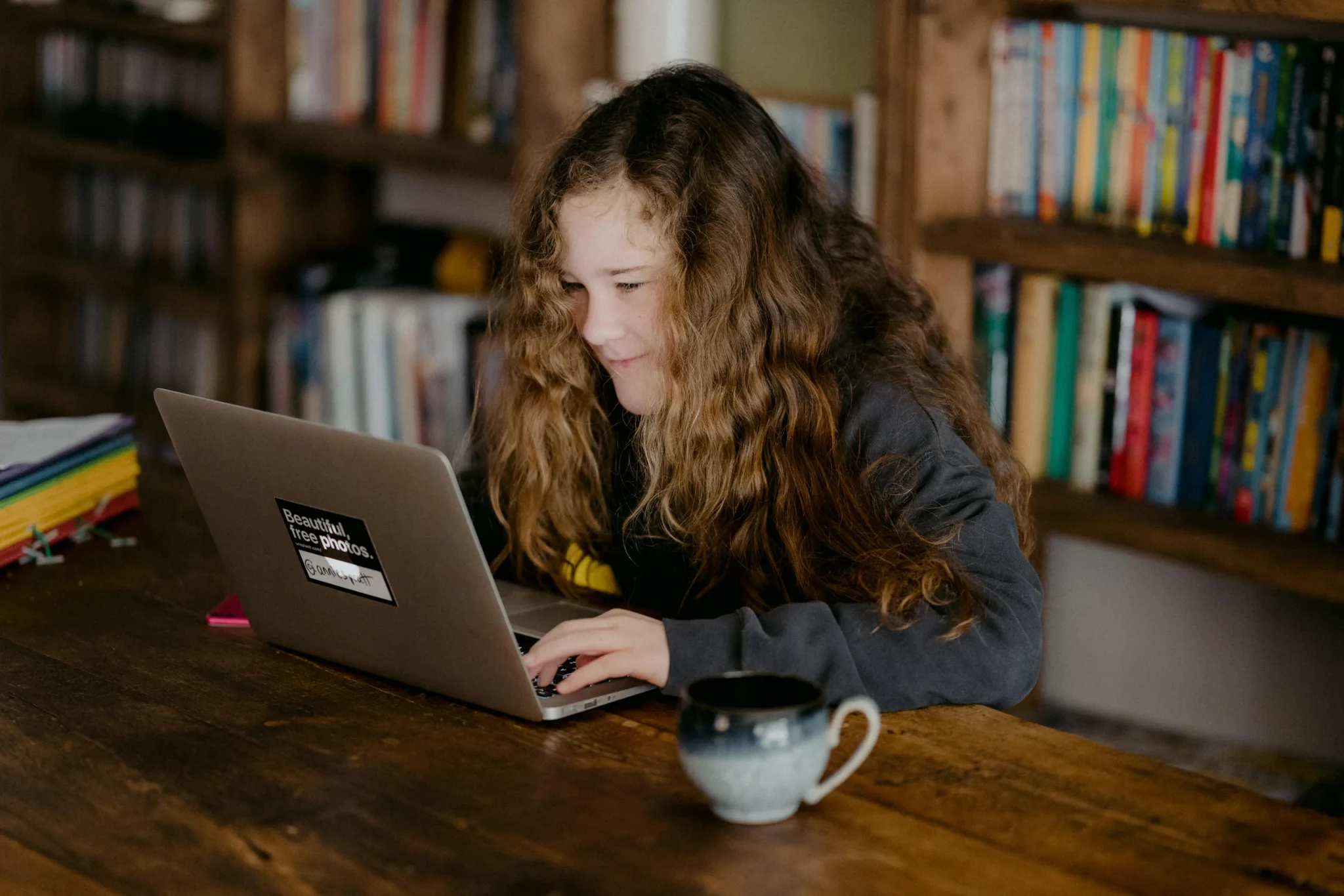 A girl pressing a laptop