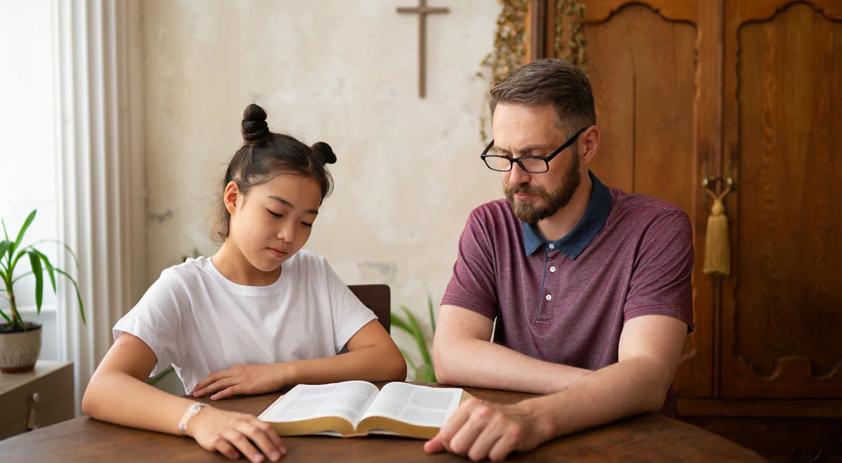 man and girl reading bible