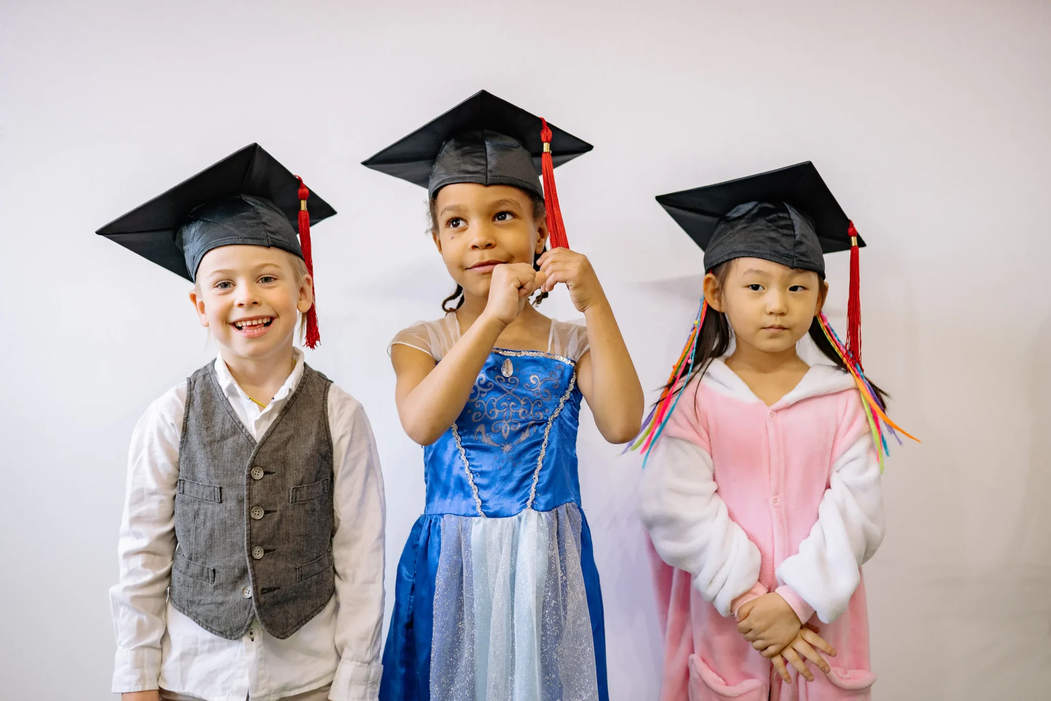 Children wearing graduation cap