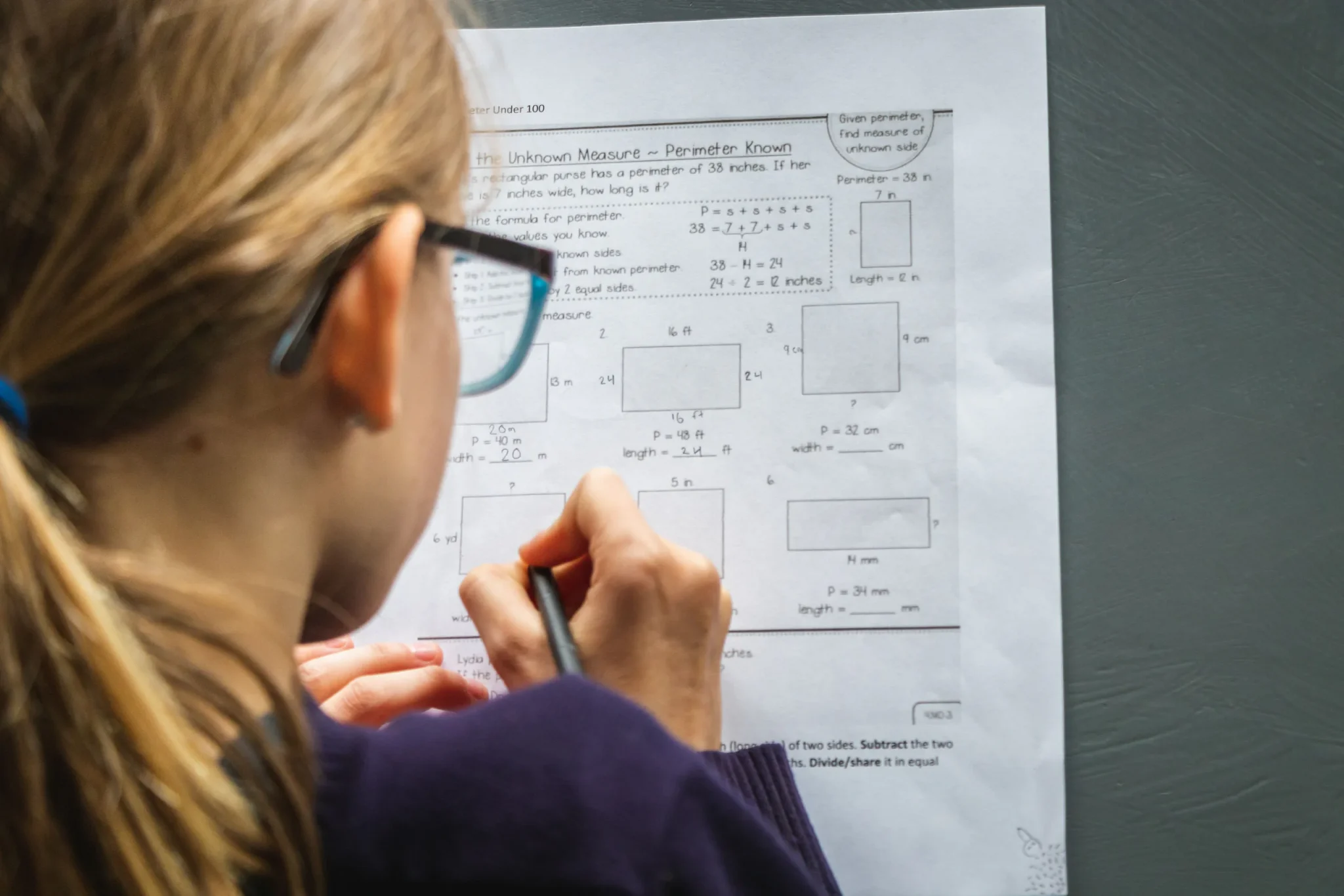 A child writing with a pen on a paper