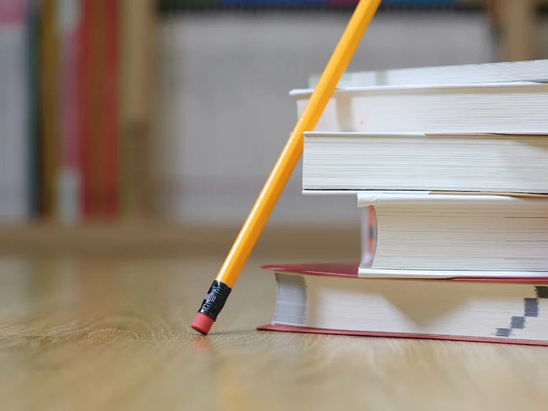 pencil leaning against books