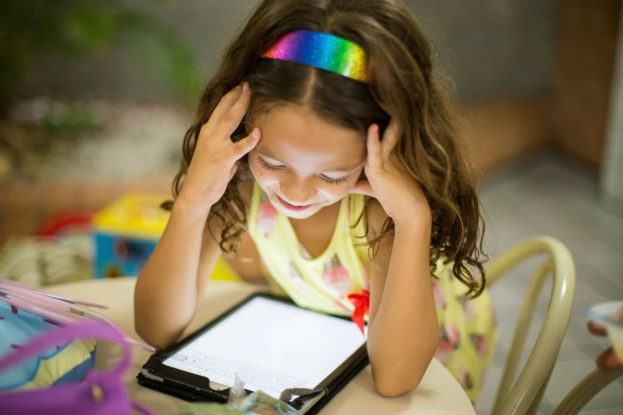 A child reading from a tablet