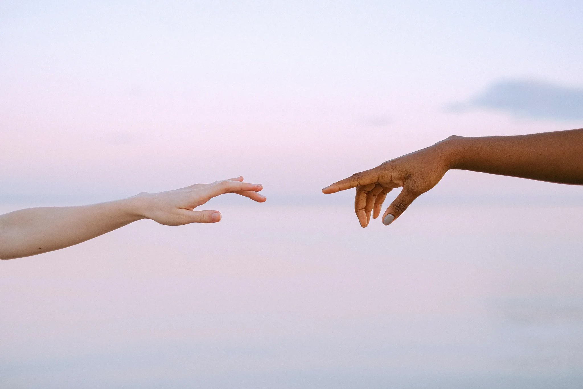 Two People Reaching Out For Each Other's Hands