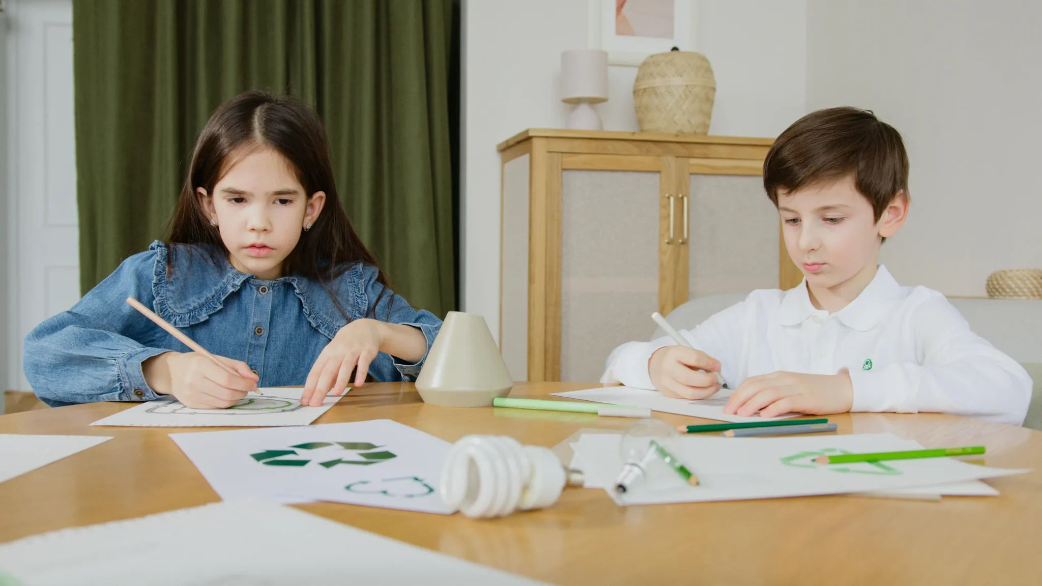 A boy and a girl holding a pen