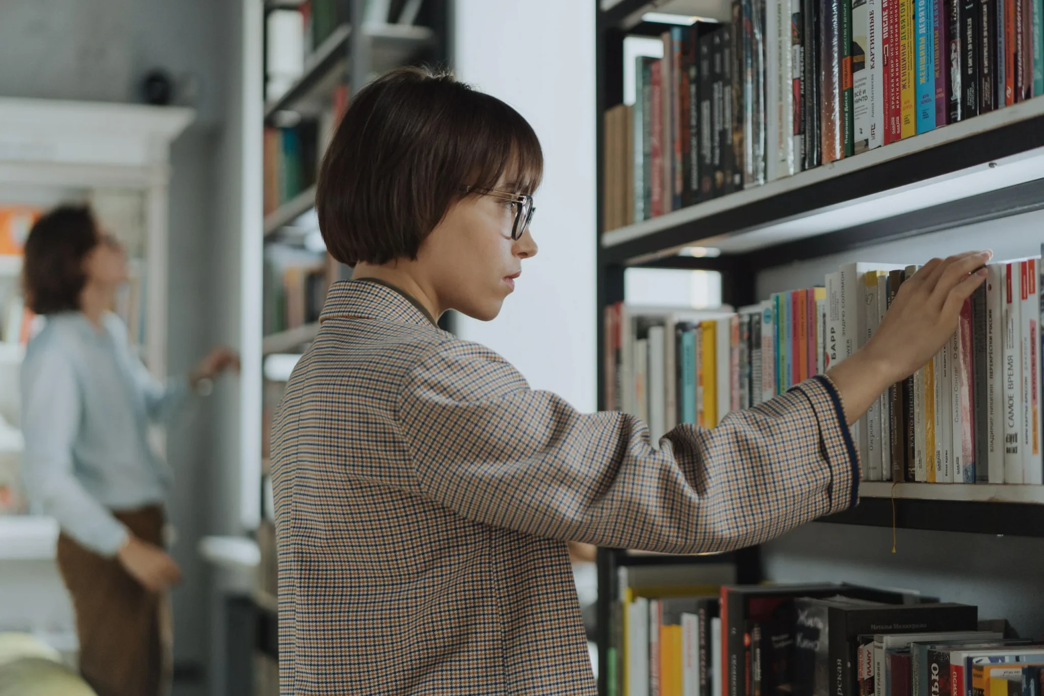 A woman scrolling through a library of books