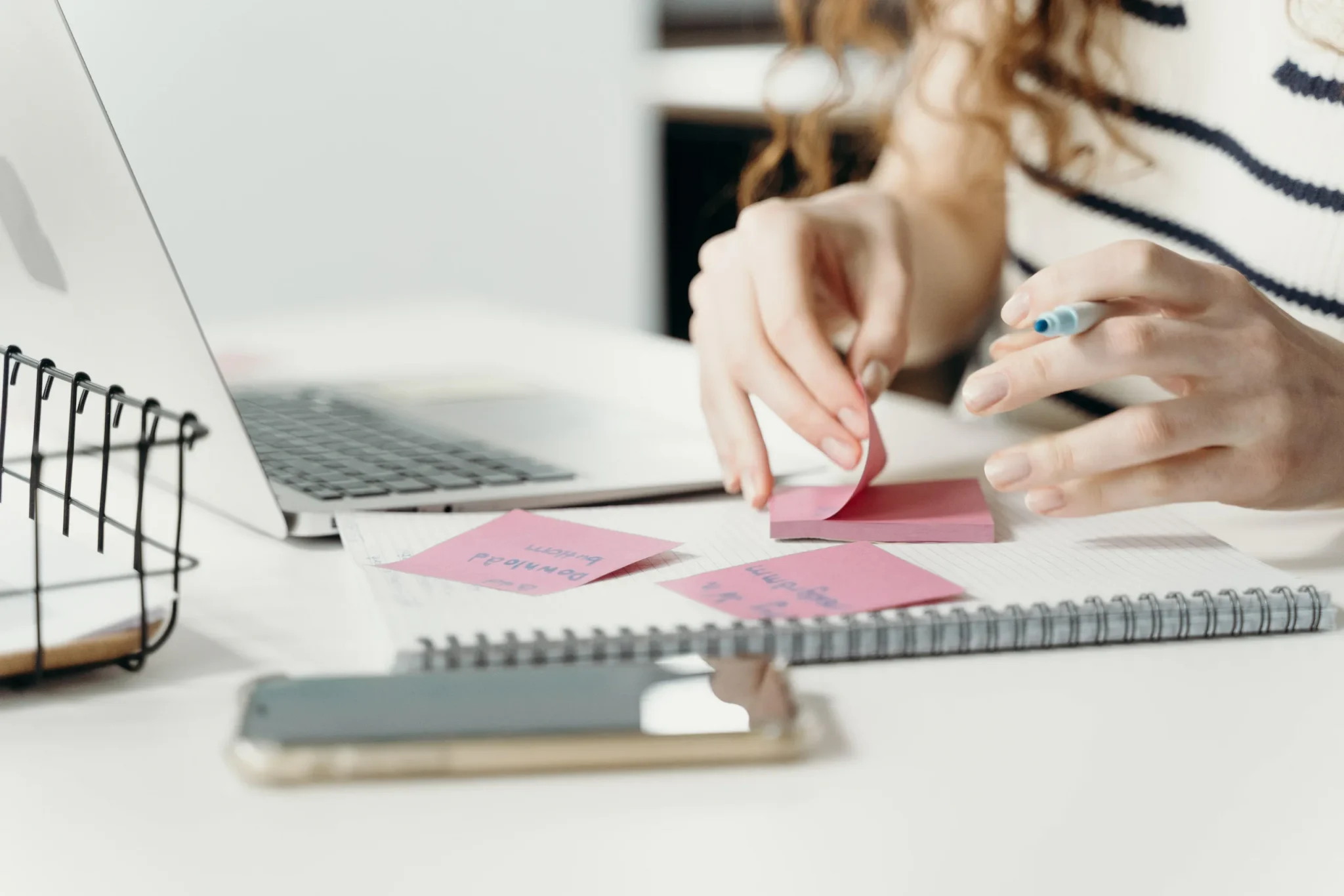 A person writing on sticky notes