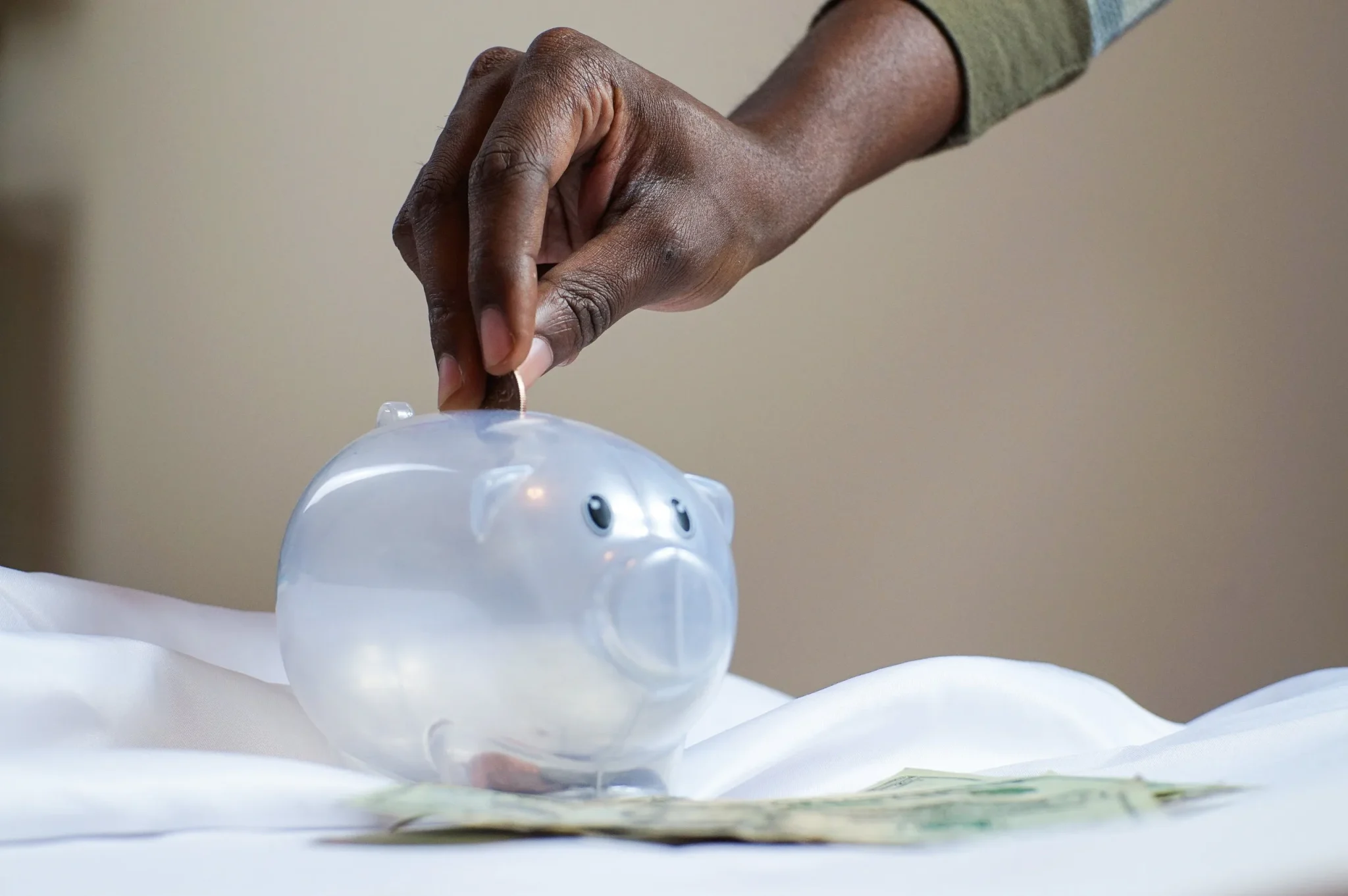 Someone saving money in a piggybank