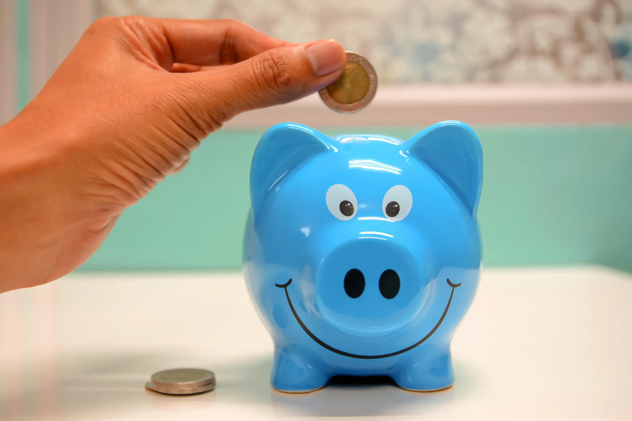 someone saving money in a piggybank