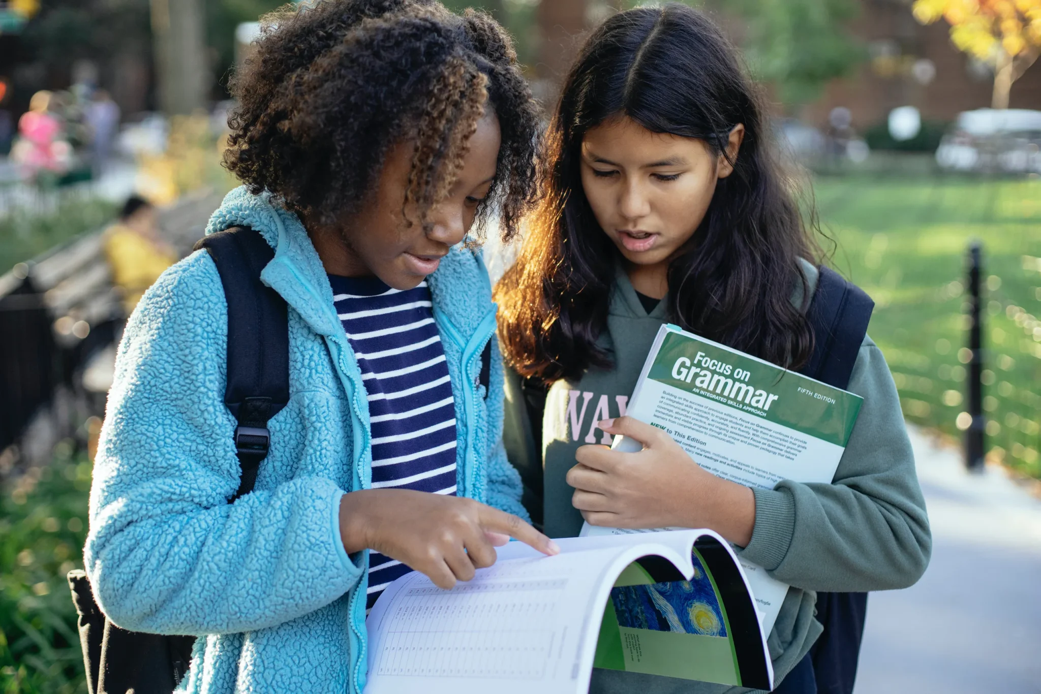 Two girls looking at a book
