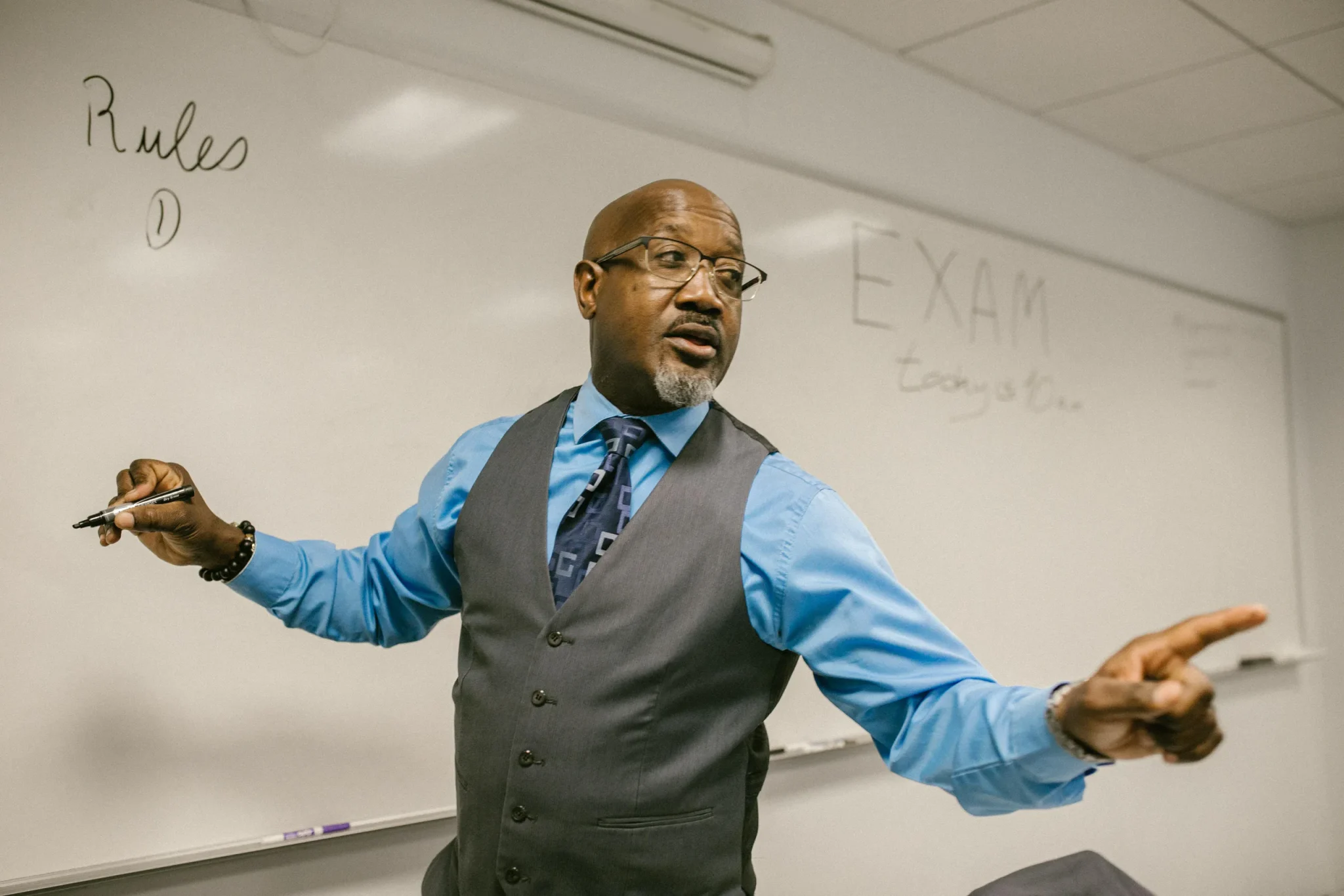 A teacher in front of a board