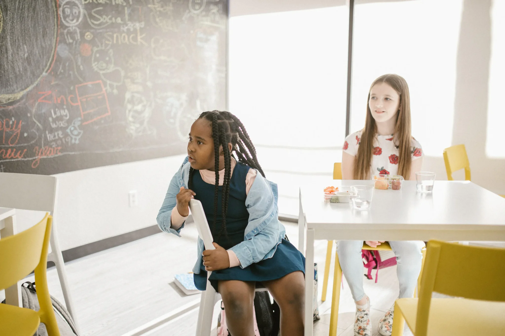Two female children staring at a board