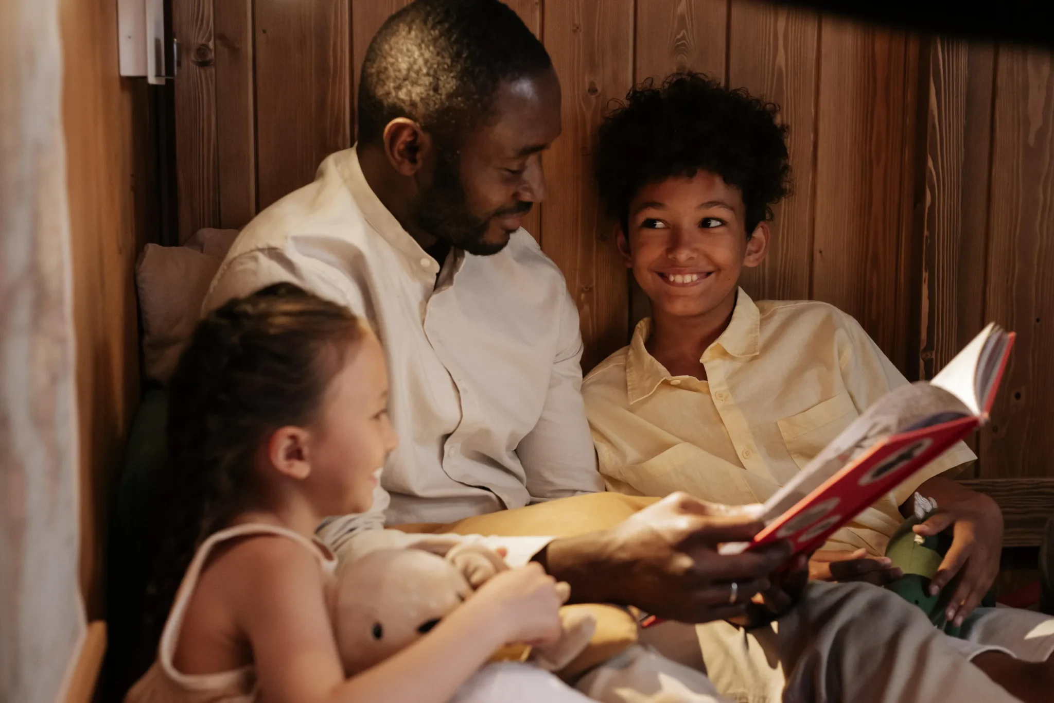 Father and his children reading a book