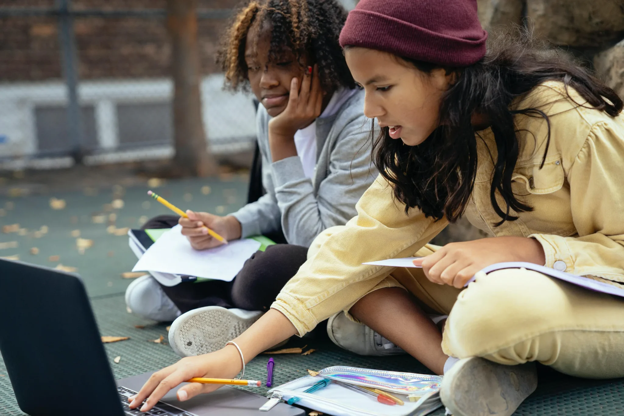 Two students working on a laptop